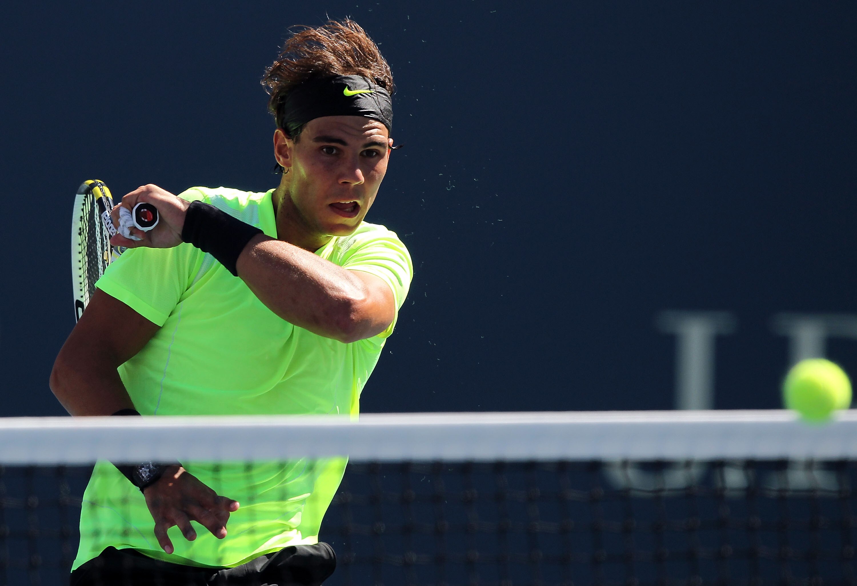 NEW YORK - SEPTEMBER 11:  Rafael Nadal of Spain returns a shot while playing against Mikhail Youzhny of Russia during his men's singles semifinal match on day thirteen of the 2010 U.S. Open at the USTA Billie Jean King National Tennis Center on September