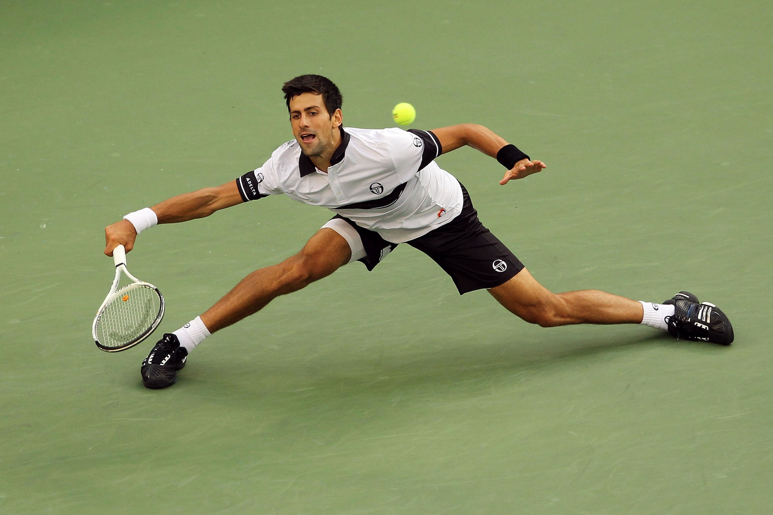 NEW YORK - SEPTEMBER 13: Novak Djokovic of Serbia returns a shot against Rafael Nadal of Spain during his men's singles final match on day fifteen of the 2010 U.S. Open at the USTA Billie Jean King National Tennis Center on September 13, 2010 in the Flus NEW YORK - SEPTEMBER 13: Novak Djokovic of Serbia returns a shot against Rafael Nadal of Spain during his men's singles final match on day fifteen of the 2010 U.S. Open at the USTA Billie Jean King National Tennis Center on September 13, 2010 in the Flus