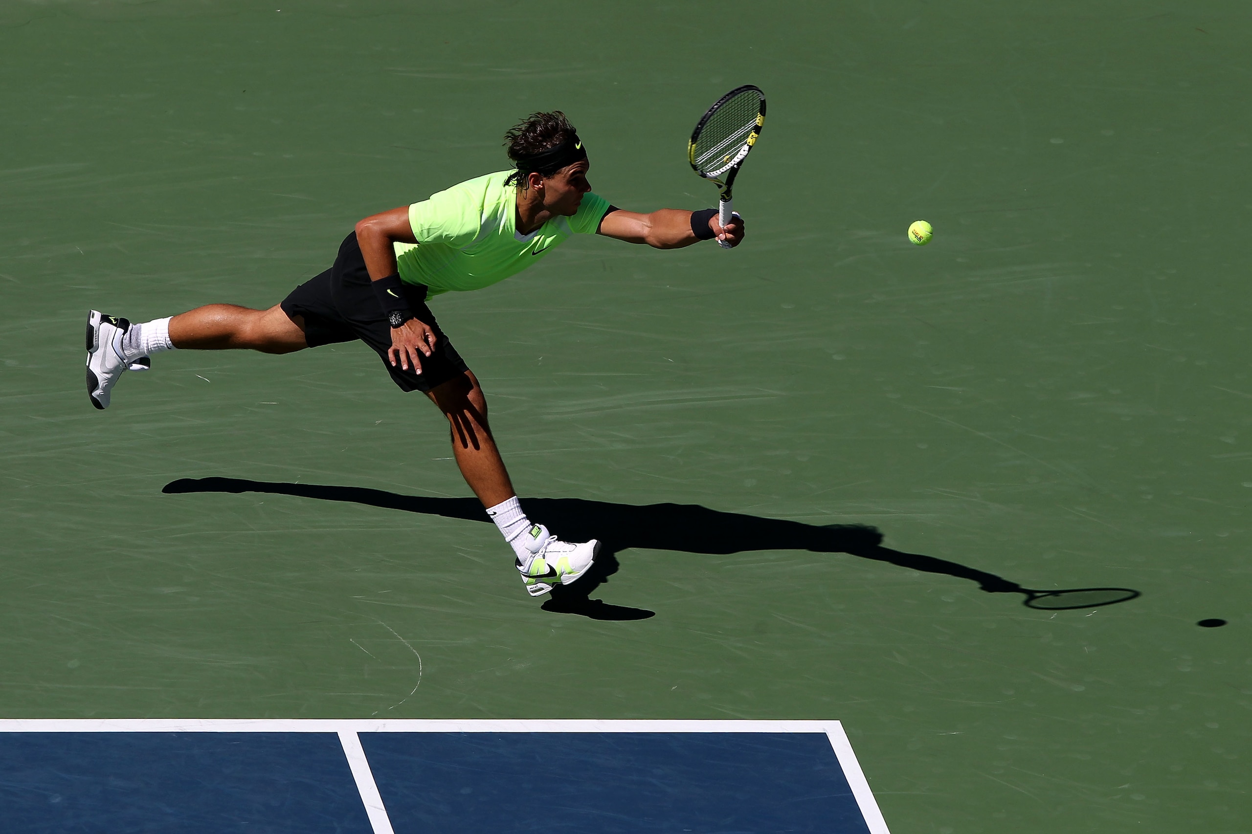 NEW YORK - SEPTEMBER 11: Rafael Nadal of Spain returns a shot while playing against Mikhail Youzhny of Russia during his men's singles semifinal match on day thirteen of the 2010 U.S. Open at the USTA Billie Jean King National Tennis Center on September NEW YORK - SEPTEMBER 11: Rafael Nadal of Spain returns a shot while playing against Mikhail Youzhny of Russia during his men's singles semifinal match on day thirteen of the 2010 U.S. Open at the USTA Billie Jean King National Tennis Center on September