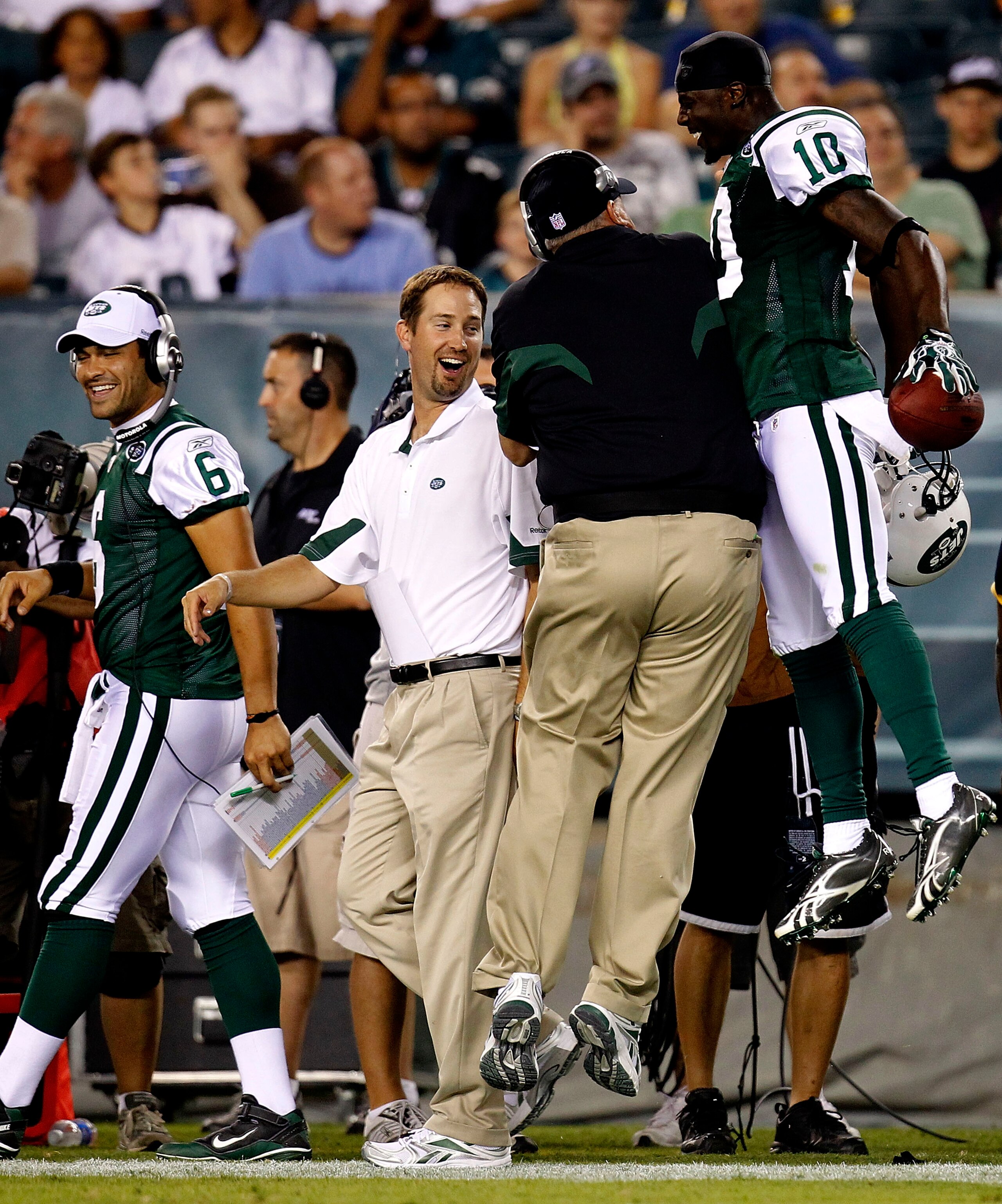PHILADELPHIA - SEPTEMBER 02: Santonio Holmes #10 and head coach Rex Ryan (back to camera) of the New York Jets celebrate a touchdown as Mark Sanchez #6 and offensive coordinator Brian Schottenheimer of the Jets look on in a preseason game against the Phil