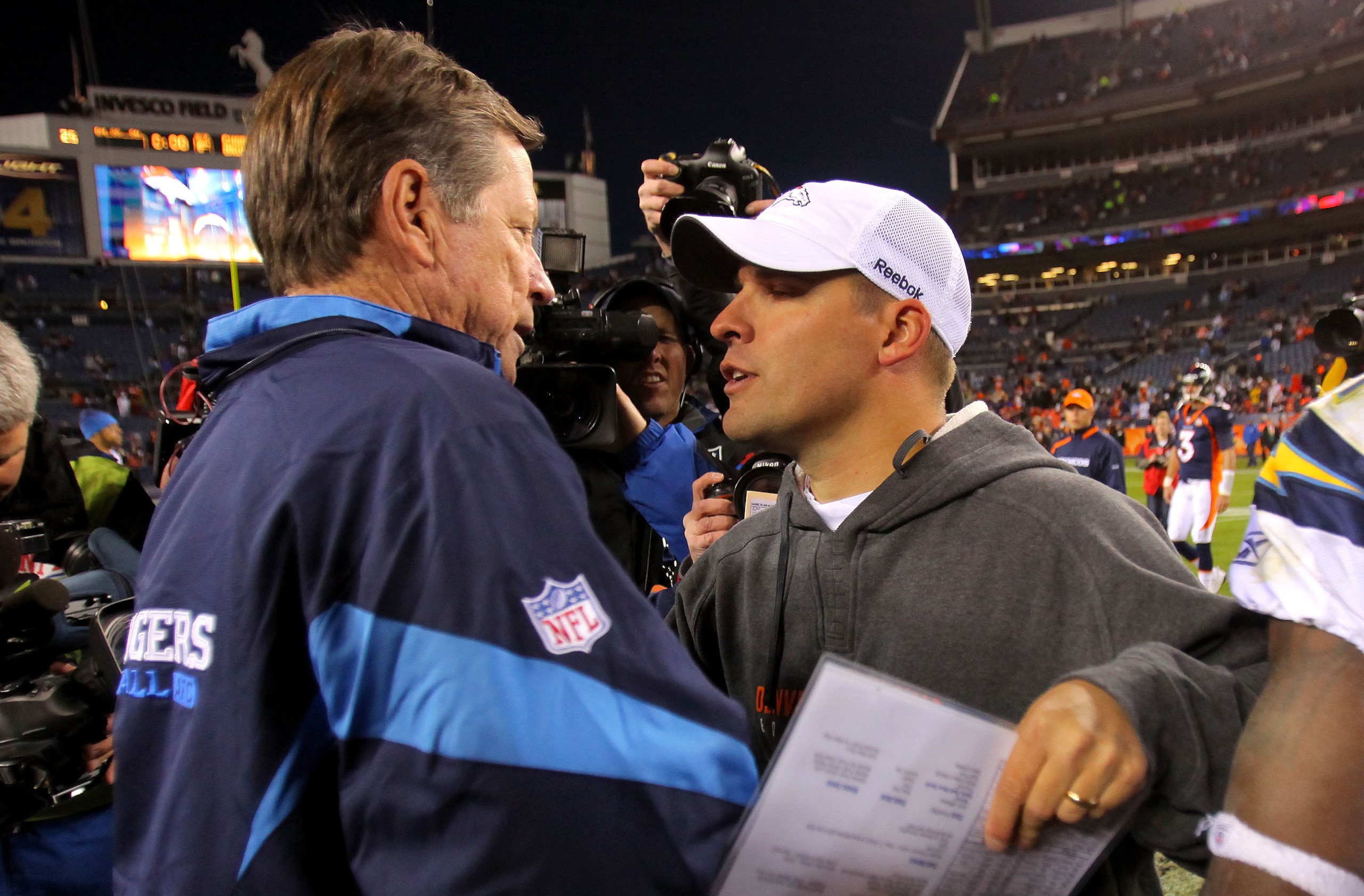 DENVER - NOVEMBER 22:  Head coach Norv Turner (L) of the San Diego Chargers and head coach Josh McDaniels (R) of the Denver Broncos meet and greet at midfield after the game during NFL action at Invesco Field at Mile High on November 22, 2009 in Denver, C