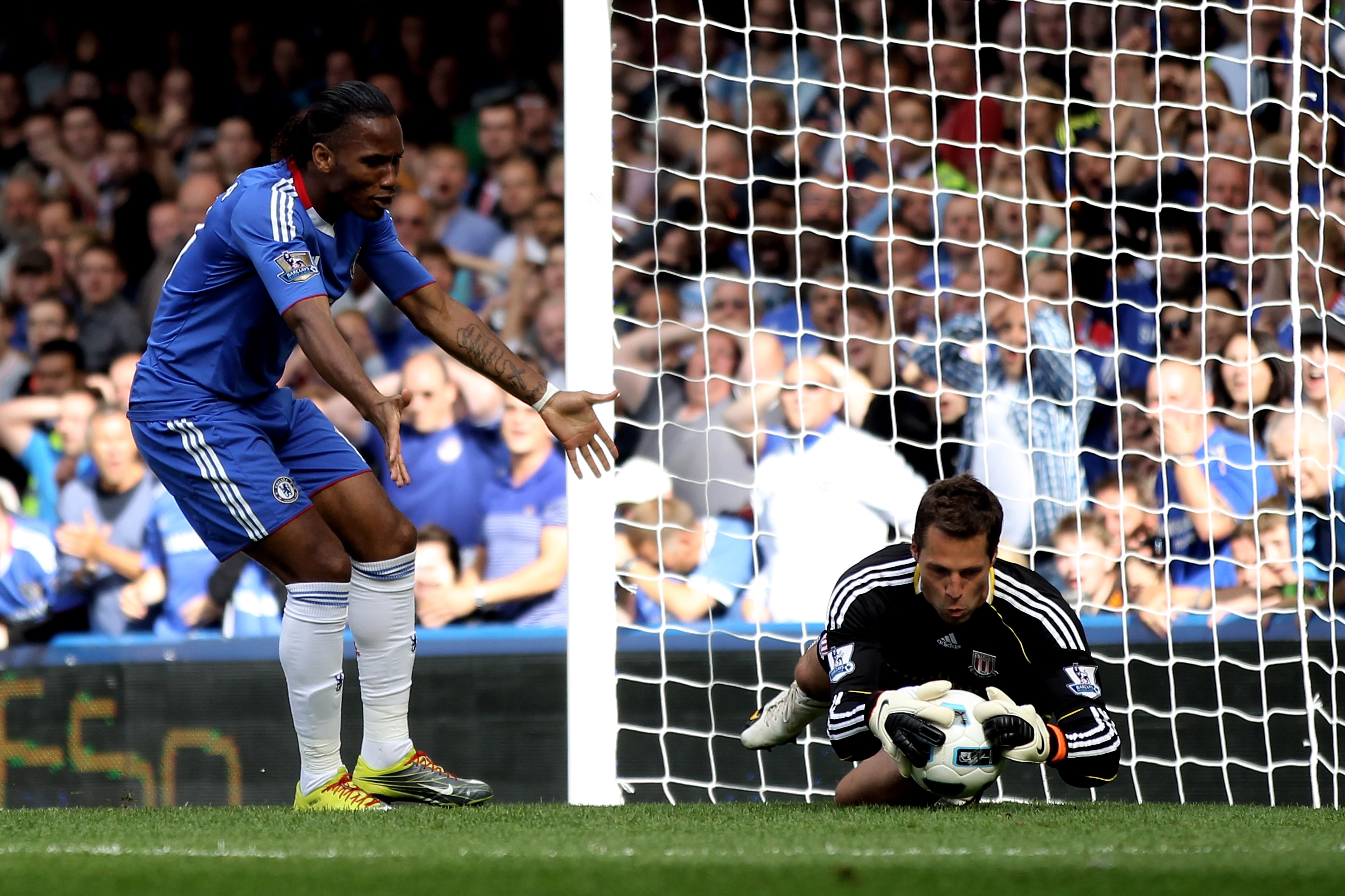 LONDON, ENGLAND - AUGUST 28: Didier Drogba of Chelsea reacts as Stoke goalkeeper Thomas Sorenson makes a save during the Barclays Premier League match between Chelsea and Stoke City at Stamford Bridge on August 28, 2010 in London, England. (Photo by Bry LONDON, ENGLAND - AUGUST 28: Didier Drogba of Chelsea reacts as Stoke goalkeeper Thomas Sorenson makes a save during the Barclays Premier League match between Chelsea and Stoke City at Stamford Bridge on August 28, 2010 in London, England. (Photo by Bry