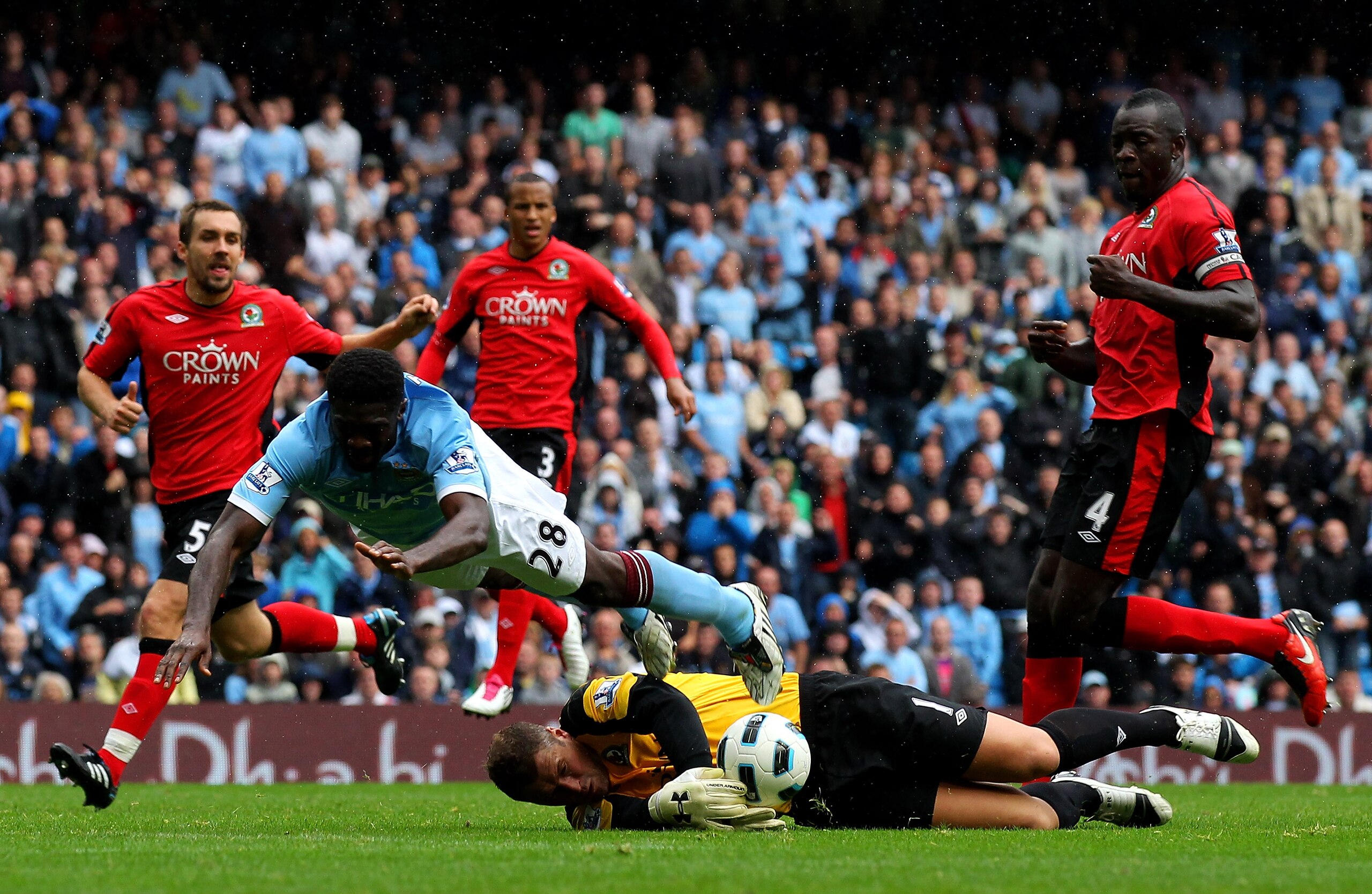 MANCHESTER, ENGLAND - SEPTEMBER 11: Paul Robinson of Blackburn Rovers dives to block the attempt on goal of Kolo Toure of Manchester City during the Barclays Premier League match between Manchester City and Blackburn Rovers at the City of Manchester Stad MANCHESTER, ENGLAND - SEPTEMBER 11: Paul Robinson of Blackburn Rovers dives to block the attempt on goal of Kolo Toure of Manchester City during the Barclays Premier League match between Manchester City and Blackburn Rovers at the City of Manchester Stad