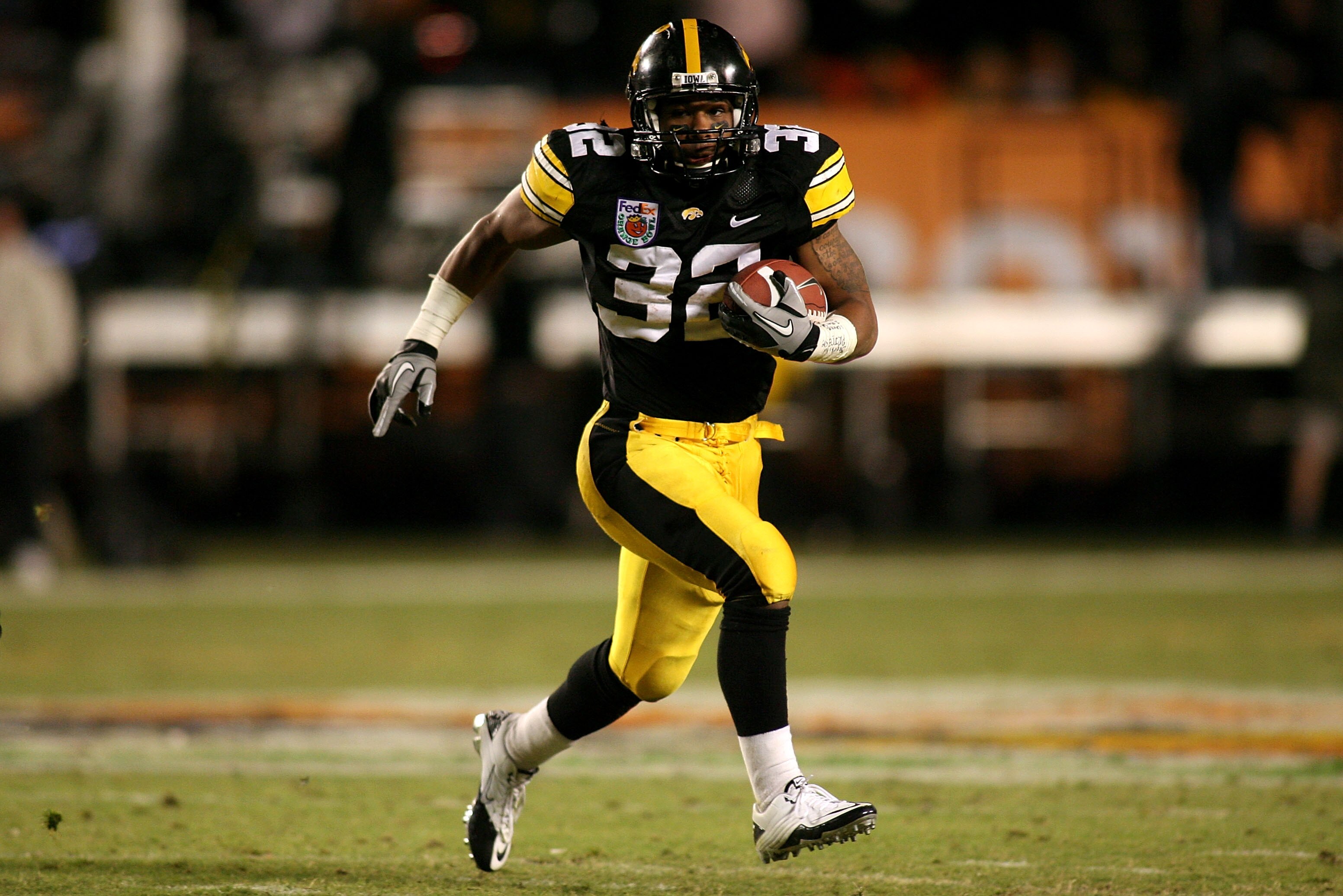 MIAMI GARDENS, FL - JANUARY 05:  Adam Robinson #32 of the Iowa Hawkeyes runs the ball against the Georgia Tech Yellow Jackets during the FedEx Orange Bowl at Land Shark Stadium on January 5, 2010 in Miami Gardens, Florida.  (Photo by Marc Serota/Getty Ima