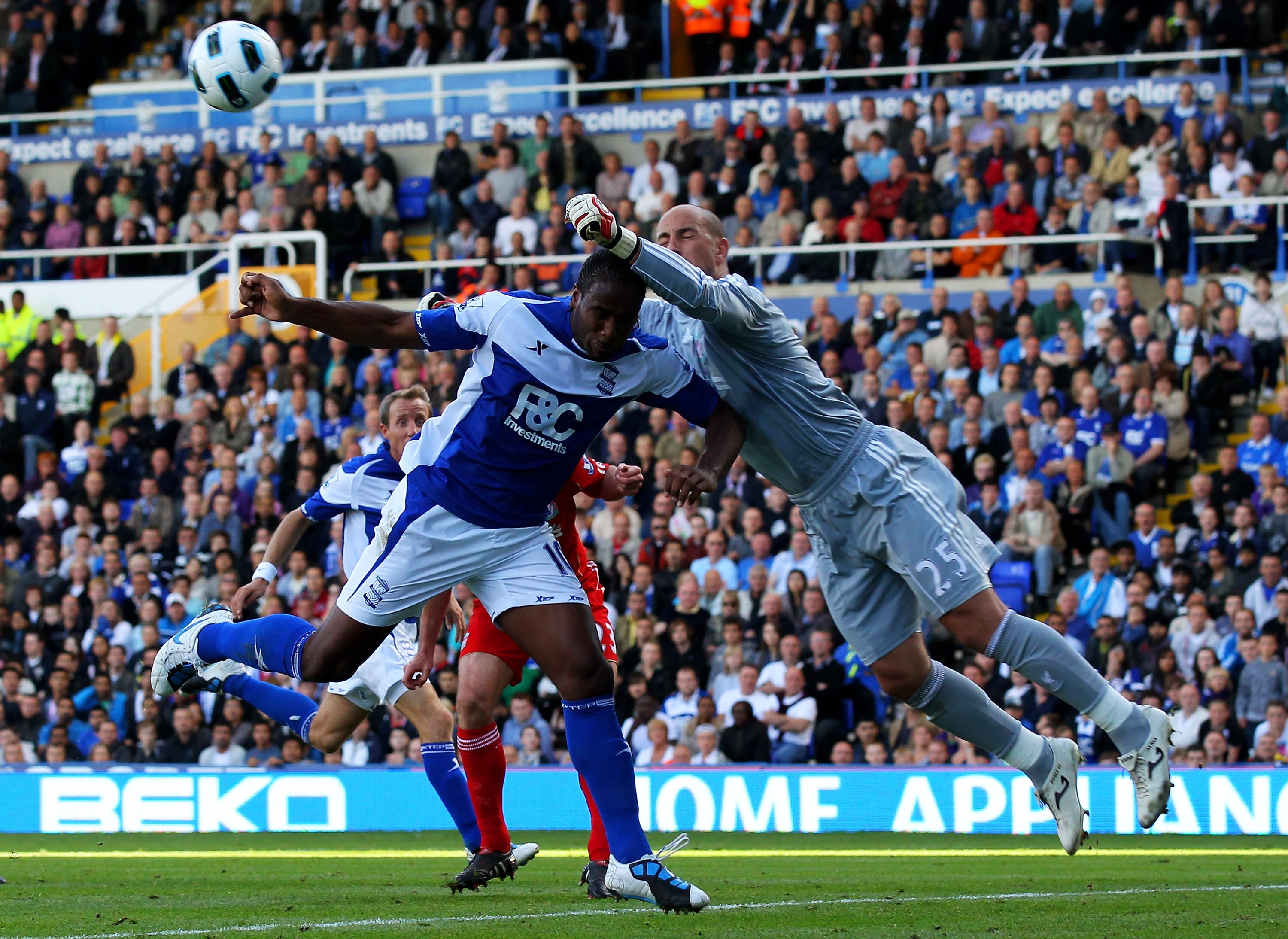 BIRMINGHAM, ENGLAND - SEPTEMBER 12: Pepe Reina of Liverpool punches clear under pressure from Cameron Jerome of Birmingham City during the Barclays Premier League match between Birmingham City and Liverpool at St Andrew's Stadium on September 12, 2010 in BIRMINGHAM, ENGLAND - SEPTEMBER 12: Pepe Reina of Liverpool punches clear under pressure from Cameron Jerome of Birmingham City during the Barclays Premier League match between Birmingham City and Liverpool at St Andrew's Stadium on September 12, 2010 in