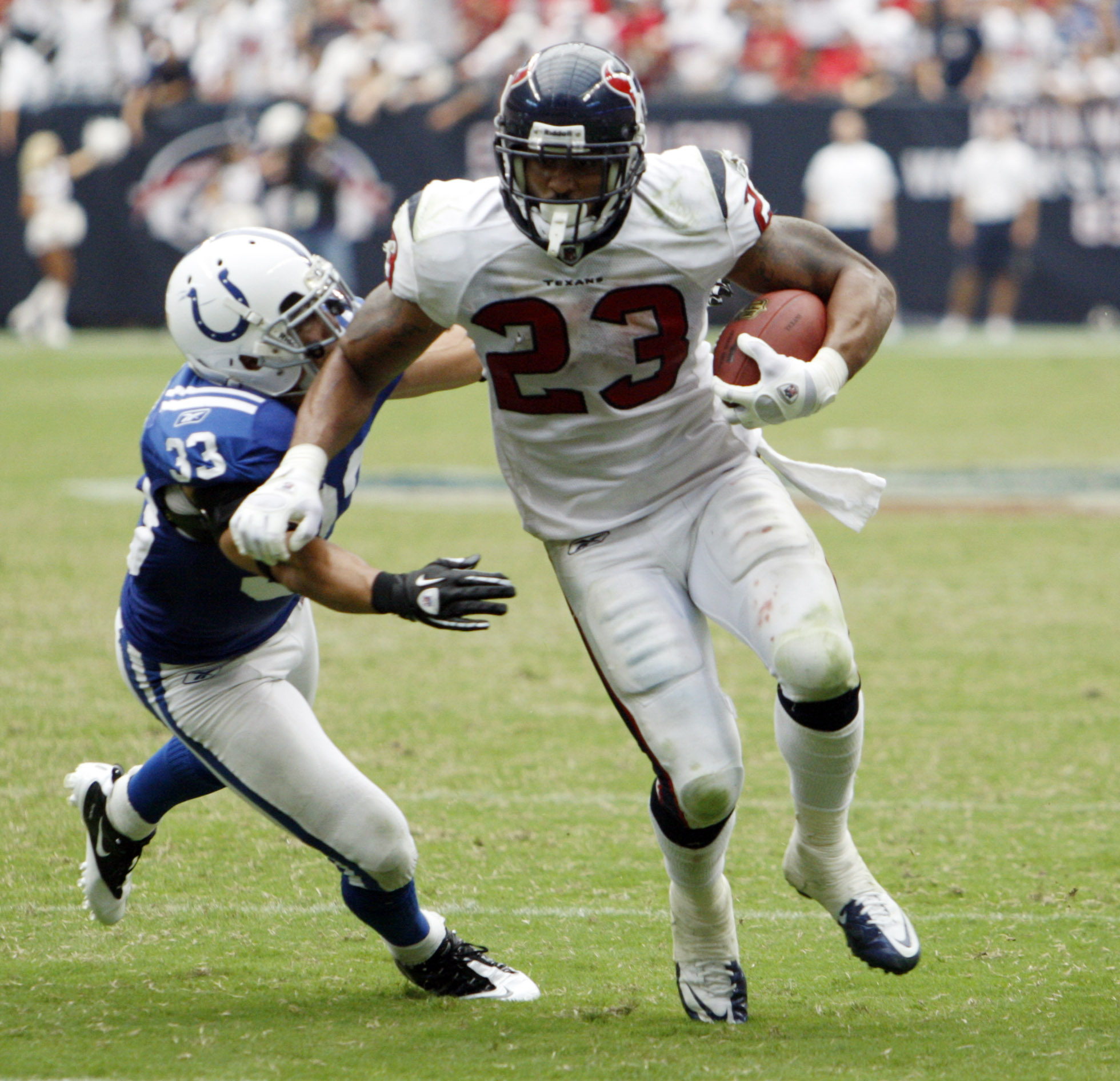 HOUSTON - SEPTEMBER 12:  Running back Arian Foster #23 of the Houston Texans avoids a tackle by defensive back Melivn Bullitt #33 of the Indianapolis Colts during the NFL season opener at Reliant Stadium on September 12, 2010 in Houston, Texas.  (Photo by