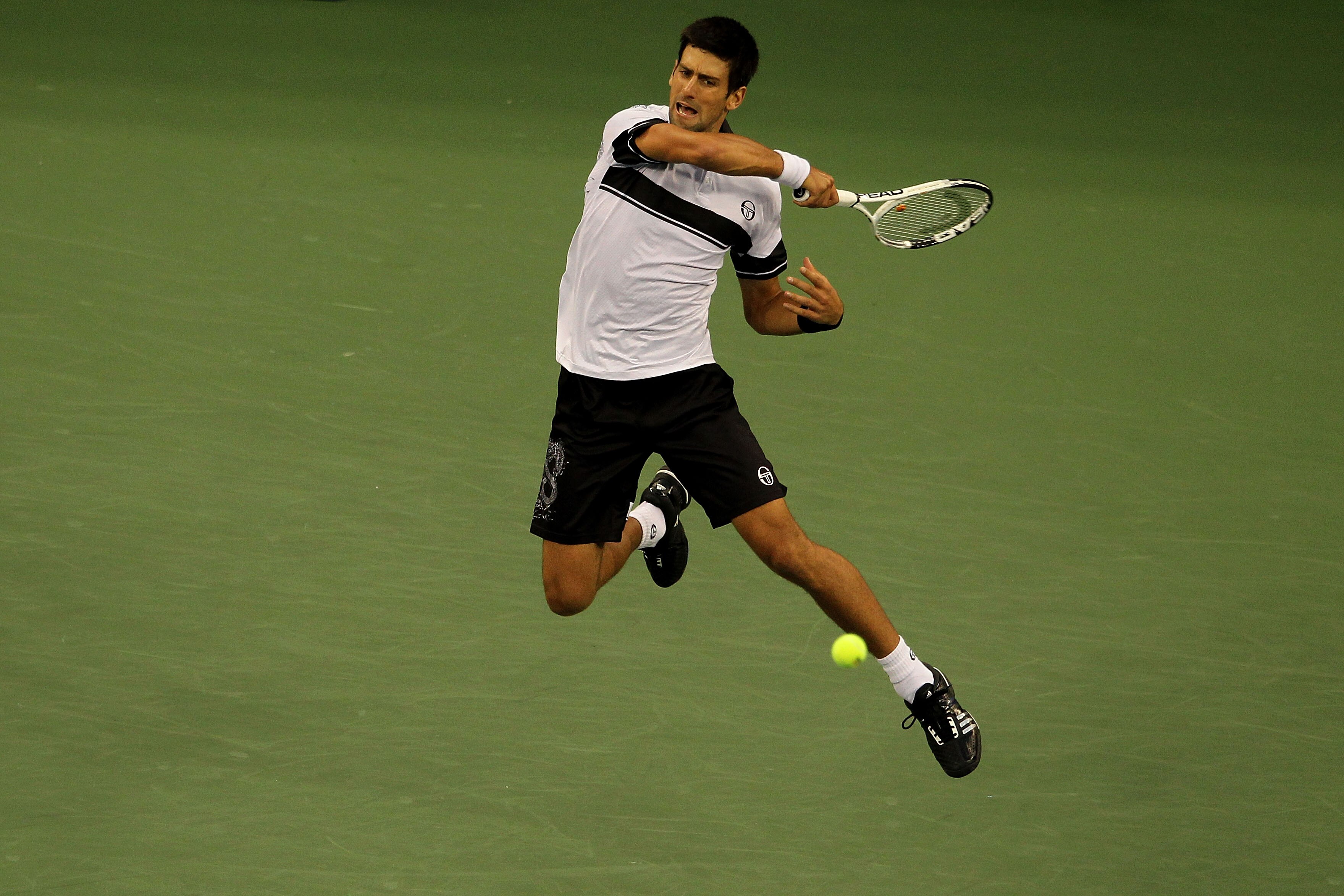 NEW YORK - SEPTEMBER 13:  Novak Djokovic of Serbia returns a shot against Rafael Nadal of Spain during his men's singles final match on day fifteen of the 2010 U.S. Open at the USTA Billie Jean King National Tennis Center on September 13, 2010 in the Flus