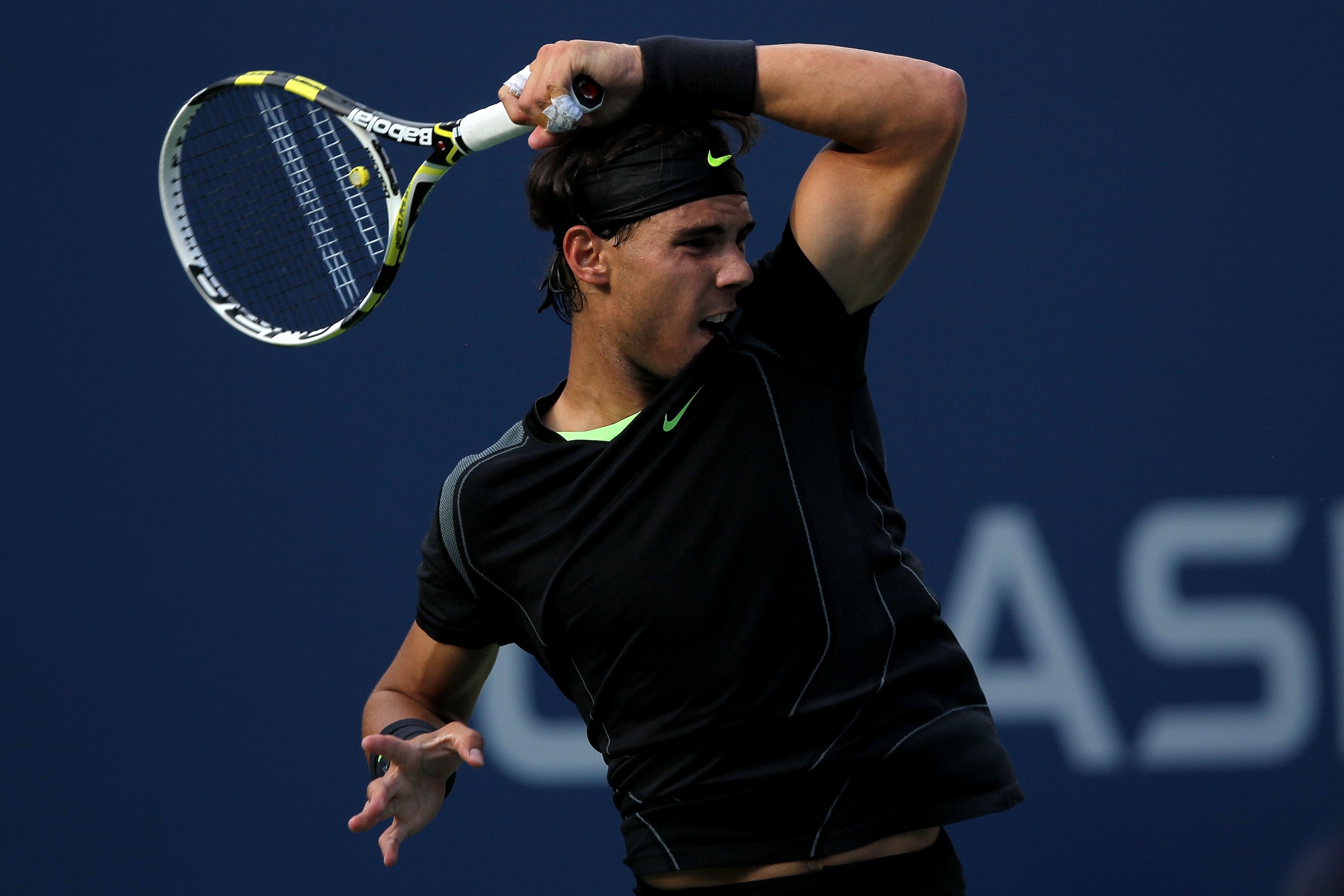 NEW YORK - SEPTEMBER 13: Rafael Nadal of Spain follows through on a return against Novak Djokovic of Serbia during his men's singles final match on day fifteen of the 2010 U.S. Open at the USTA Billie Jean King National Tennis Center on September 13, 201 NEW YORK - SEPTEMBER 13: Rafael Nadal of Spain follows through on a return against Novak Djokovic of Serbia during his men's singles final match on day fifteen of the 2010 U.S. Open at the USTA Billie Jean King National Tennis Center on September 13, 201