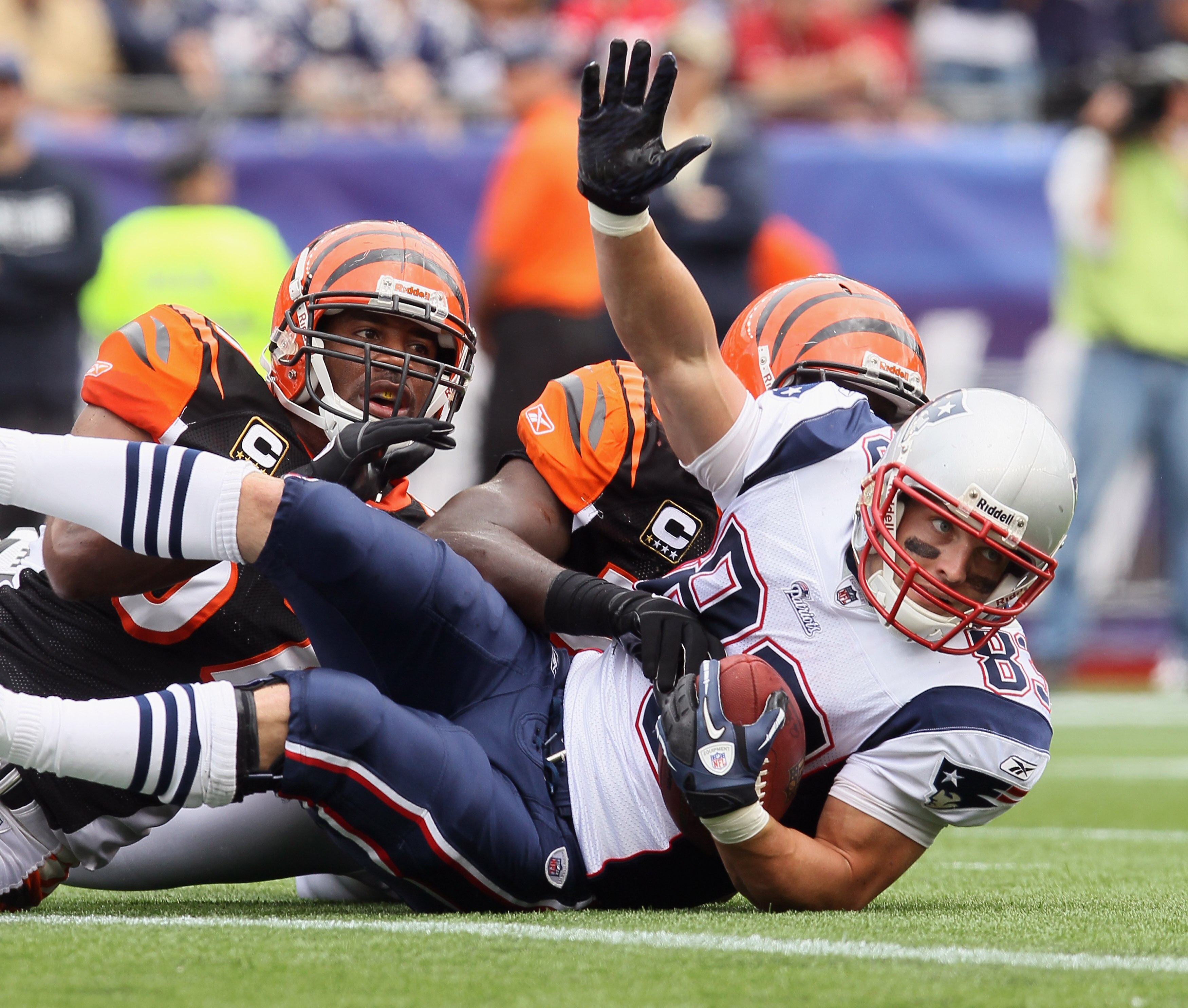 FOXBORO, MA - SEPTEMBER 12:  Wes Welker #83 of the New England Patriots falls into the endzone to score a touchdown as Dhani Jones #57 and Brandon Johnson #59 of the Cincinnati Bengals defend during the NFL season opener on September 12, 2010 at Gillette