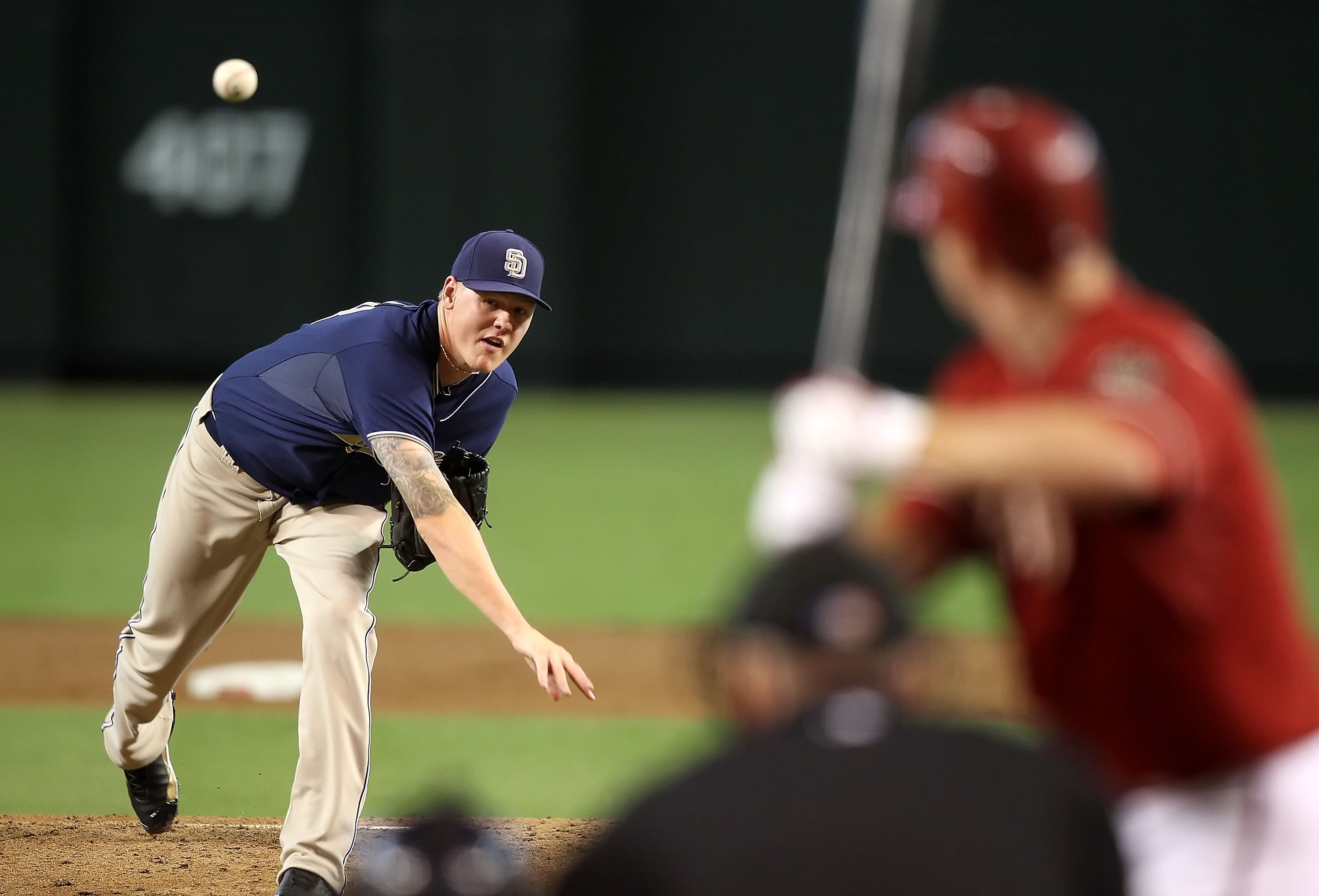 PHOENIX - SEPTEMBER 01:  Starting pitcher Mat Latos #38 of the San Diego Padres pitches against Adam LaRoche #25 of the Arizona Diamondbacks during the Major League Baseball game at Chase Field on September 1, 2010 in Phoenix, Arizona. The Diamondbacks de