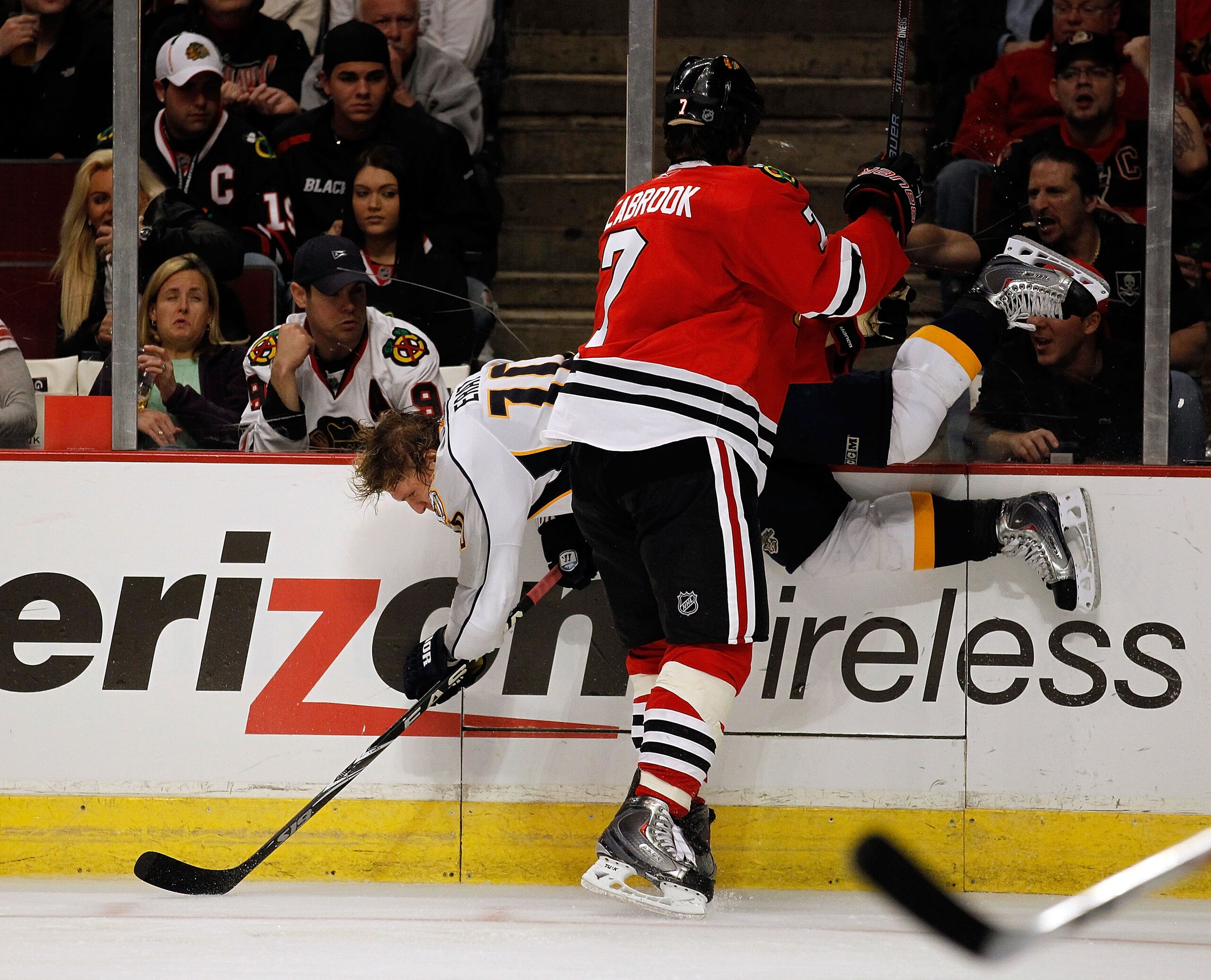 CHICAGO - APRIL 24: Brent Seabrook #7 of the Chicago Blackhawks checks Martin Erat #10 of the Nashville Predators into the boards in Game Five of the Western Conference Quarterfinals during the 2010 NHL Stanley Cup Playoffs at the United Center on April 2