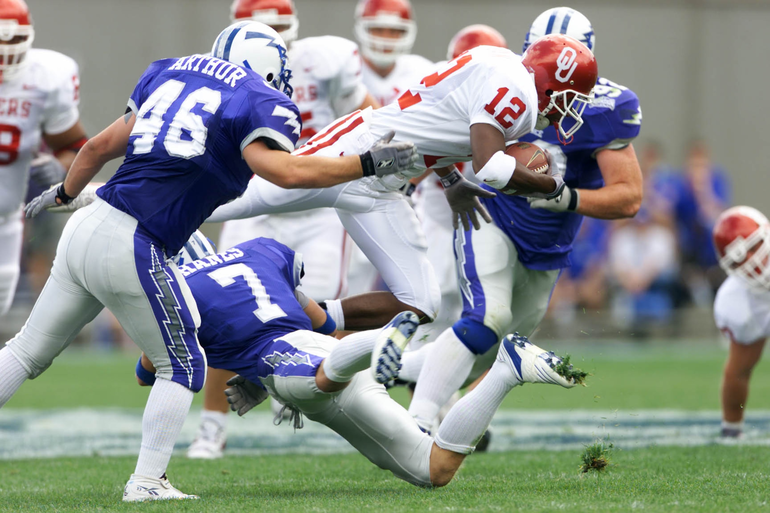 01 Sep 2001: Curtis Fagan #12 of the Oklahoma Sooners breaks through the defense of Adam Hanes #7 and Jamie Arthur #46 of the Air Force Falcons during the game at Falcon Stadium in Colorado Springs, Colorado. Oklahoma won 44-3. DIGITAL IMAGE. Mandatory Cr