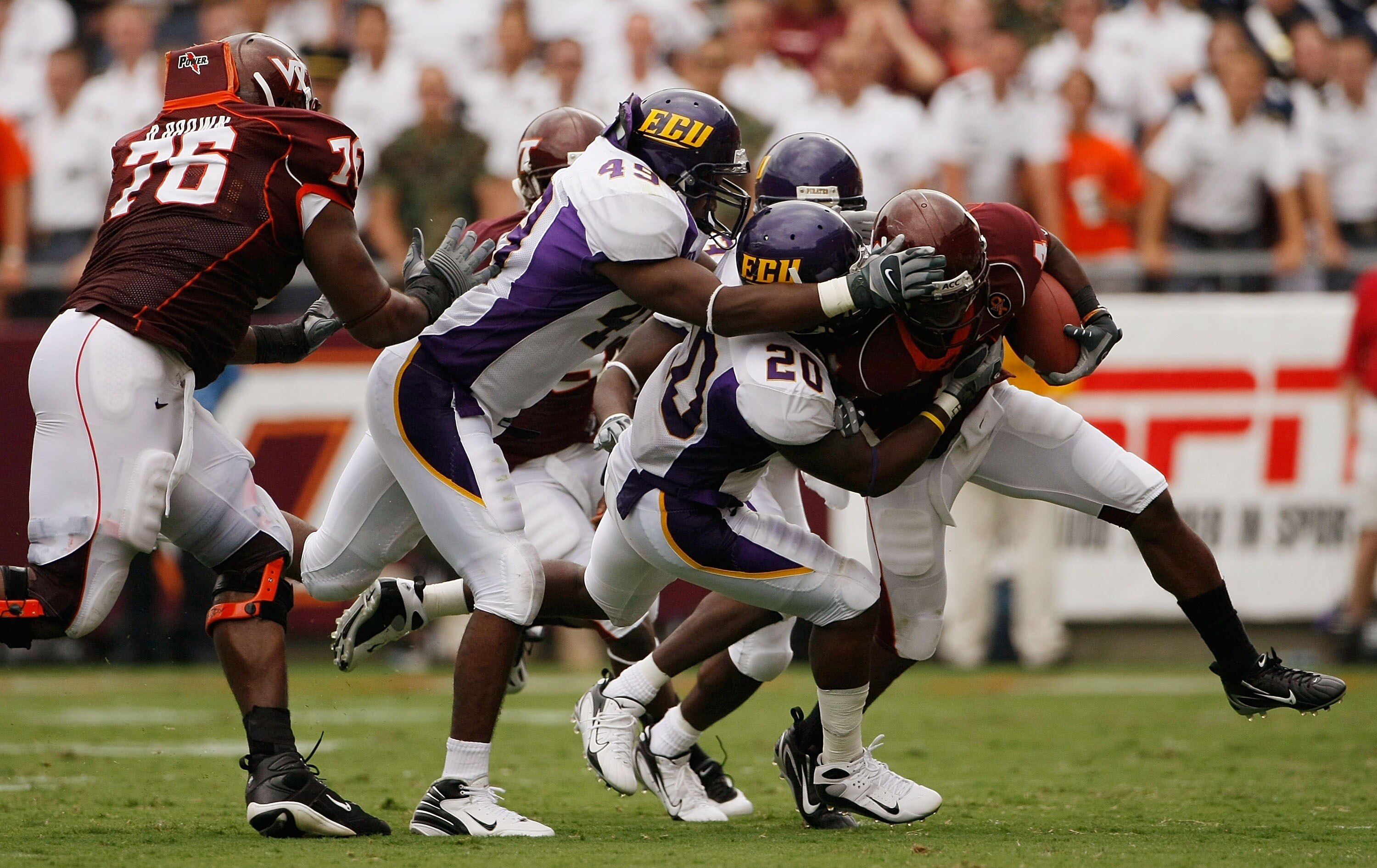 BLACKSBURG, VA - SEPTEMBER 01:  Flanker Eddie Royal #4 of the Virginia Tech Hokies is gang tackled by a group of East Carolina Pirate defenders in fourth quarter action on September 1, 2007 at Lane Stadium in Blacksburg, Virginia. Virginia Tech won the ga