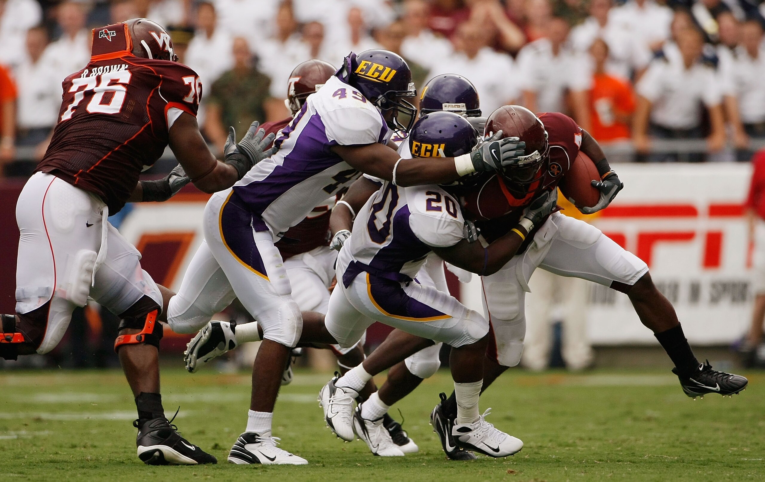 BLACKSBURG, VA - SEPTEMBER 01:  Flanker Eddie Royal #4 of the Virginia Tech Hokies is gang tackled by a group of East Carolina Pirate defenders in fourth quarter action on September 1, 2007 at Lane Stadium in Blacksburg, Virginia. Virginia Tech won the ga