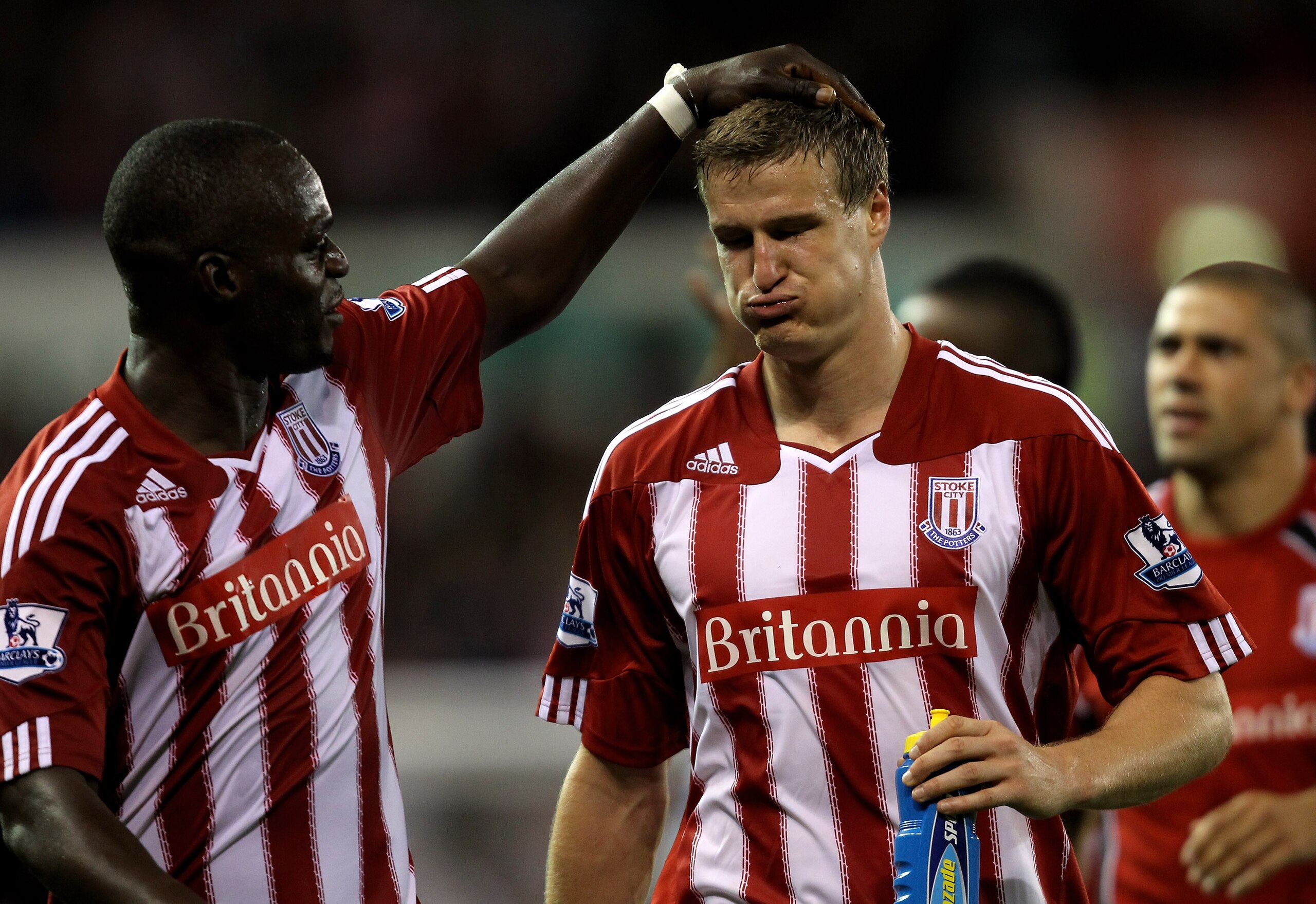 STOKE ON TRENT, ENGLAND - SEPTEMBER 13:   Robert Huth of Stoke City is congratulated by team mate Abdoulaye Faye at the end of the Barclays Premier League match between Stoke City and Aston Villa at The Britannia Stadium on September 13, 2010 in Stoke on