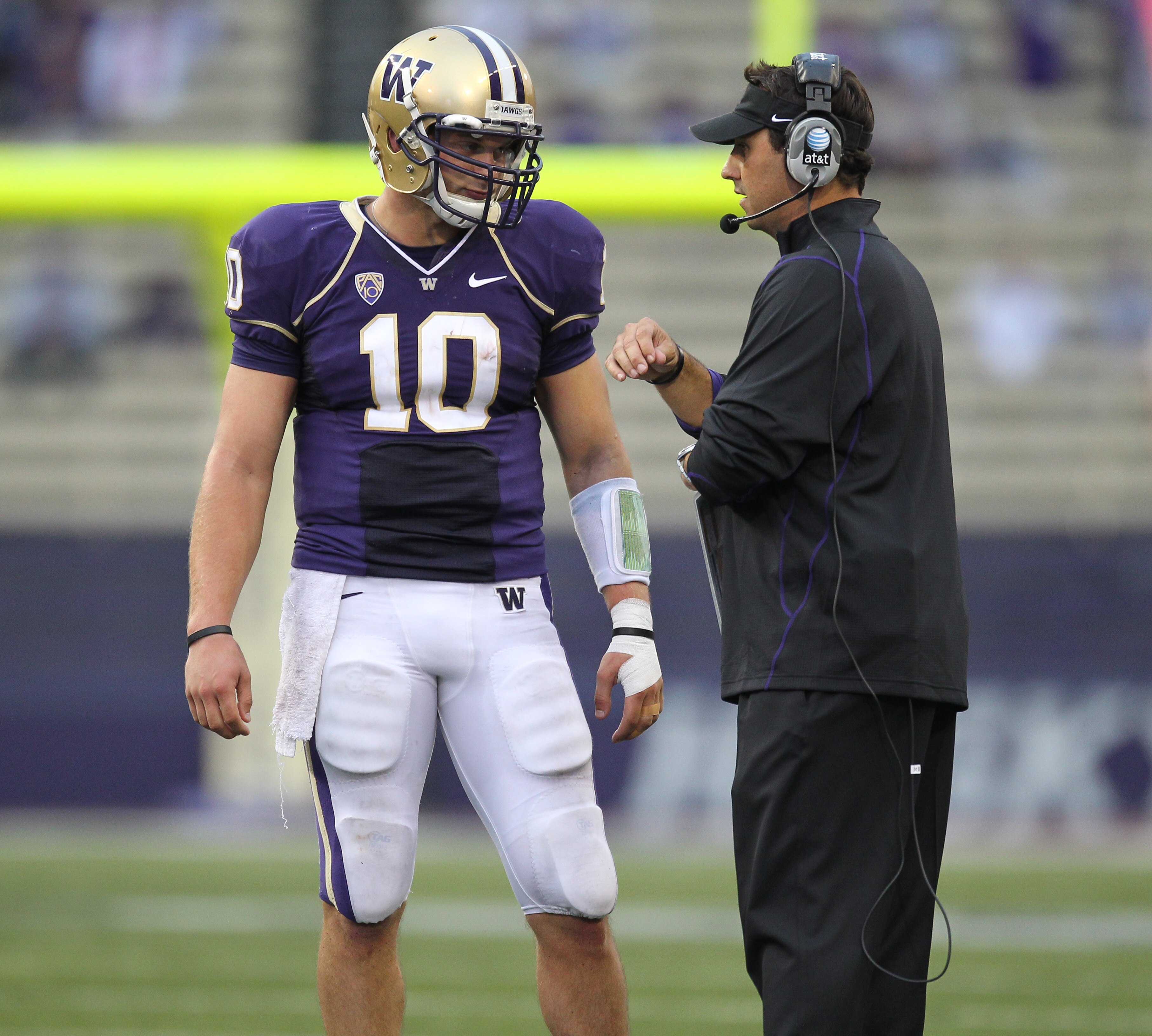 SEATTLE - SEPTEMBER 11:  Head coach Steve Sarkisian of the Washington Huskies talks with quarterback Jake Locker #10 during the game against the Syracuse Orange on September 11, 2010 at Husky Stadium in Seattle, Washington. (Photo by Otto Greule Jr/Getty