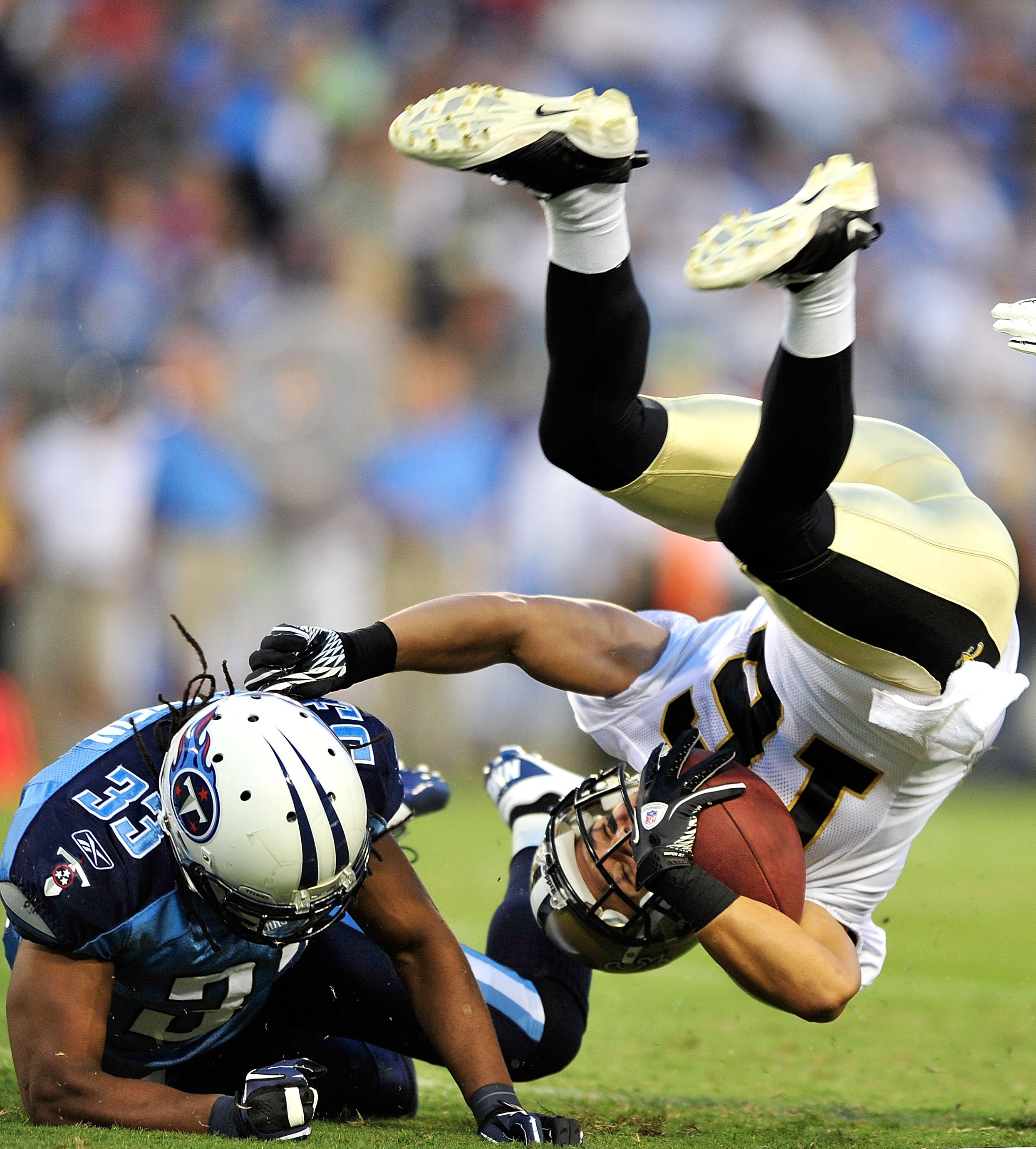NASHVILLE, TN - SEPTEMBER 02:  Michael Griffin #33 of the Tennessee Titans upends Lance Moore #16 of the New Orleans Saints during an exhibition game at LP Field on September 2, 2010 in Nashville, Tennessee.  (Photo by Grant Halverson/Getty Images)