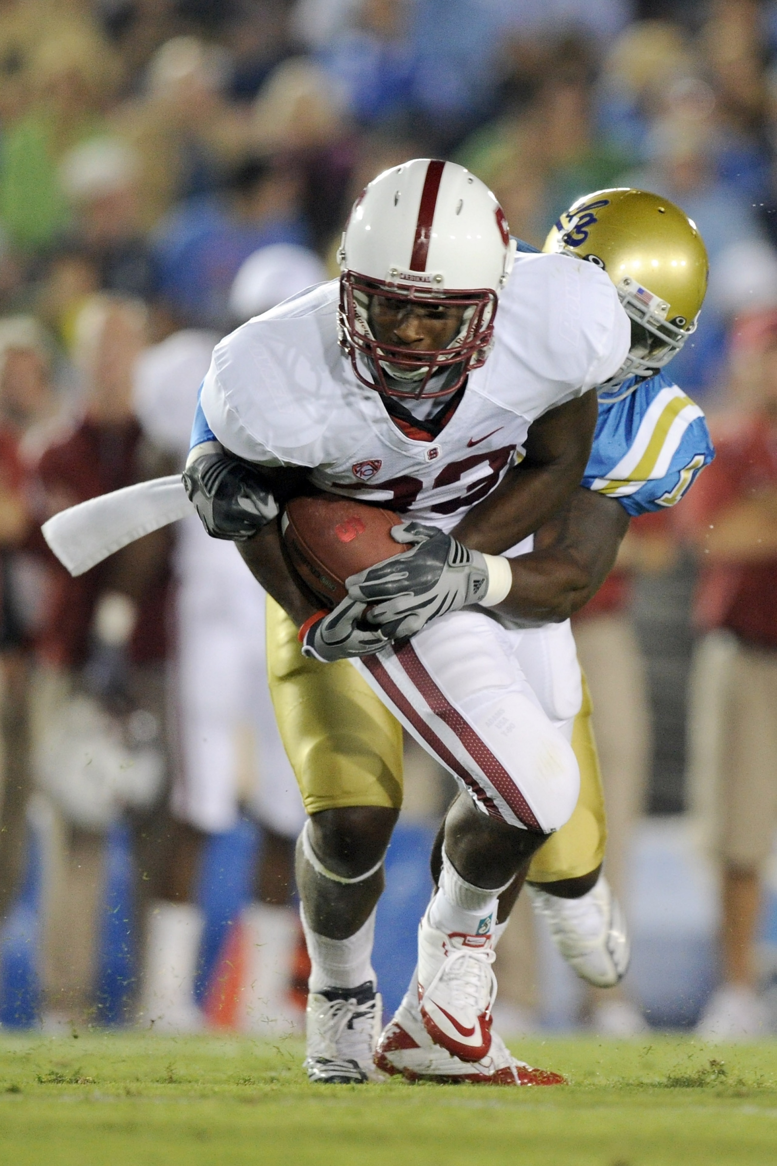PASADENA, CA - SEPTEMBER 11:  Stepfan Taylor #33 of Stanford is tackled by Akeem Ayers #10 of UCLA during the game at the Rose Bowl on September 11, 2010 in Pasadena, California.  (Photo by Harry How/Getty Images)
