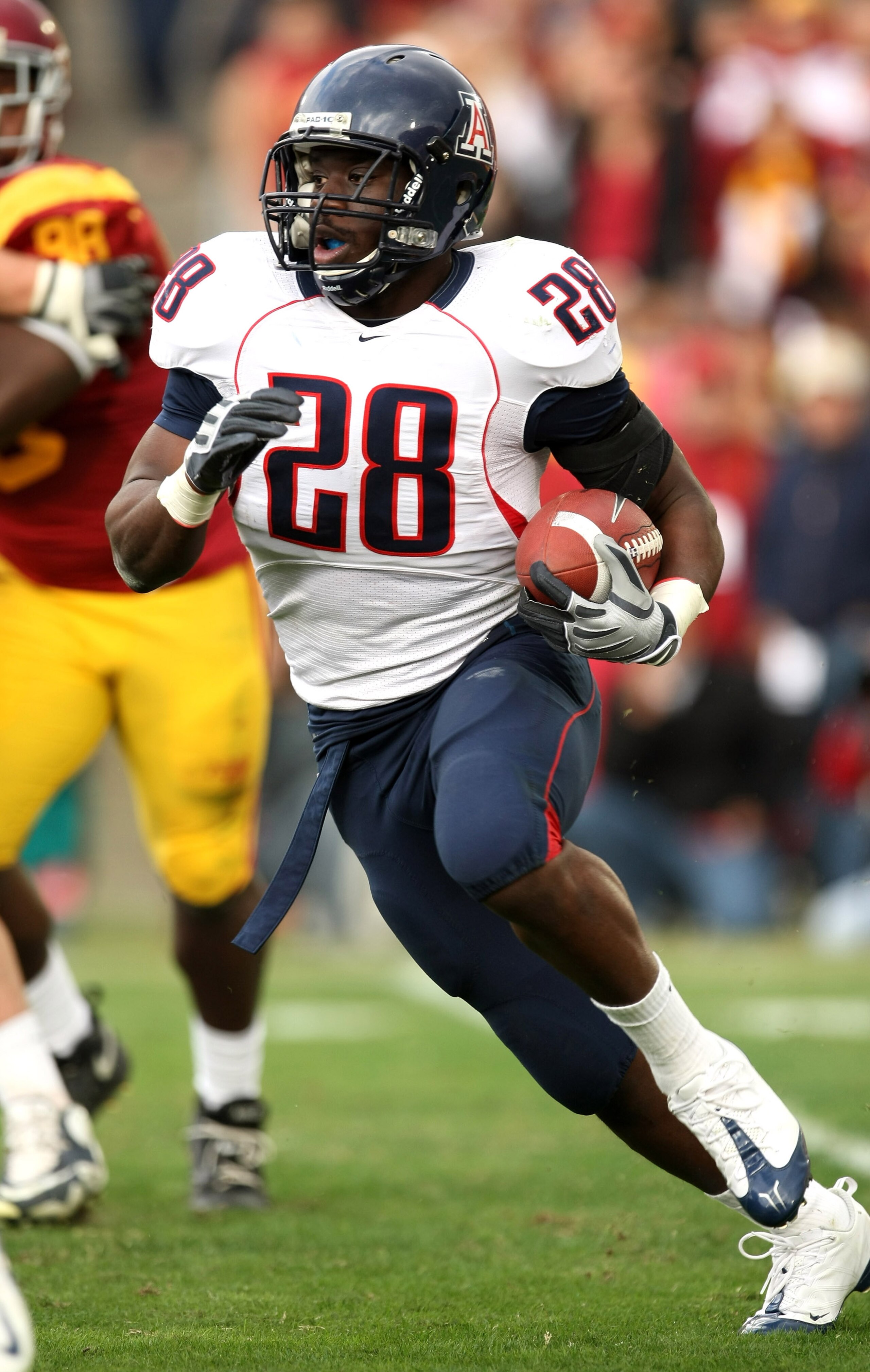LOS ANGELES - DECEMBER 5:  Running back Greg Nwoko #28 of the Arizona Wildcats carries the ball against the USC Trojans on December 5, 2009 at the Los Angeles Coliseum in Los Angeles, California.   (Photo by Stephen Dunn/Getty Images)