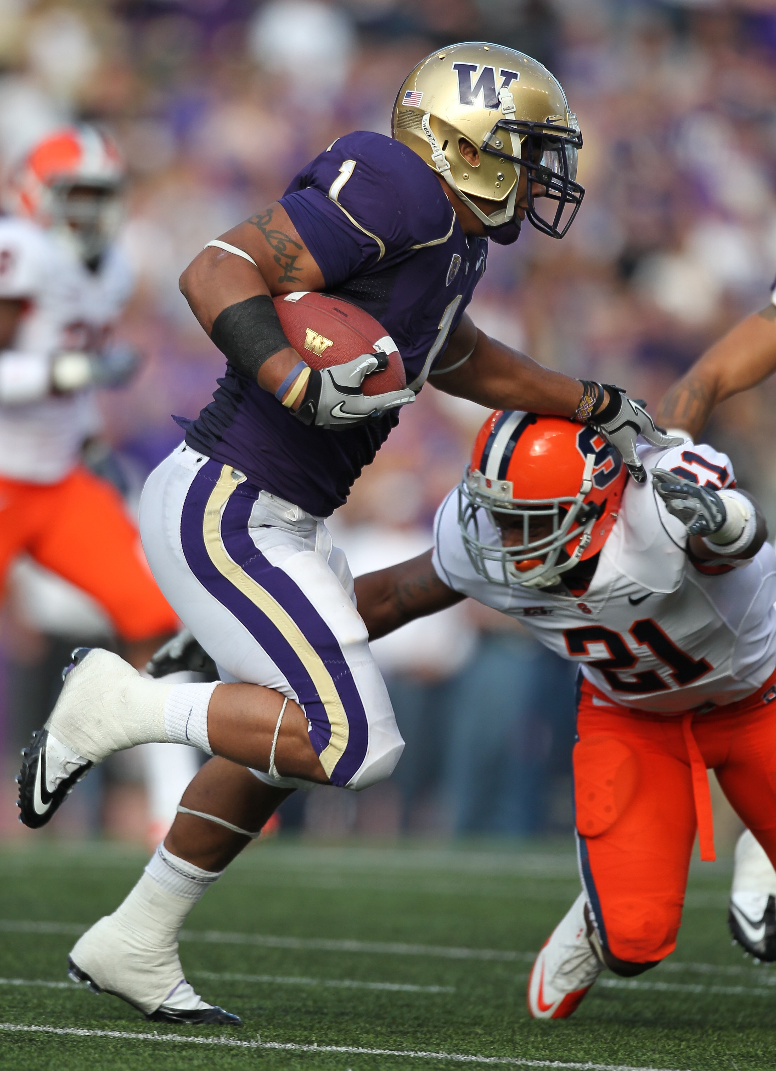 SEATTLE - SEPTEMBER 11:  Running back Chris Polk #1 of the Washington Huskies rushes against Shamarko Thomas #21 of the Syracuse Orange on September 11, 2010 at Husky Stadium in Seattle, Washington. (Photo by Otto Greule Jr/Getty Images)