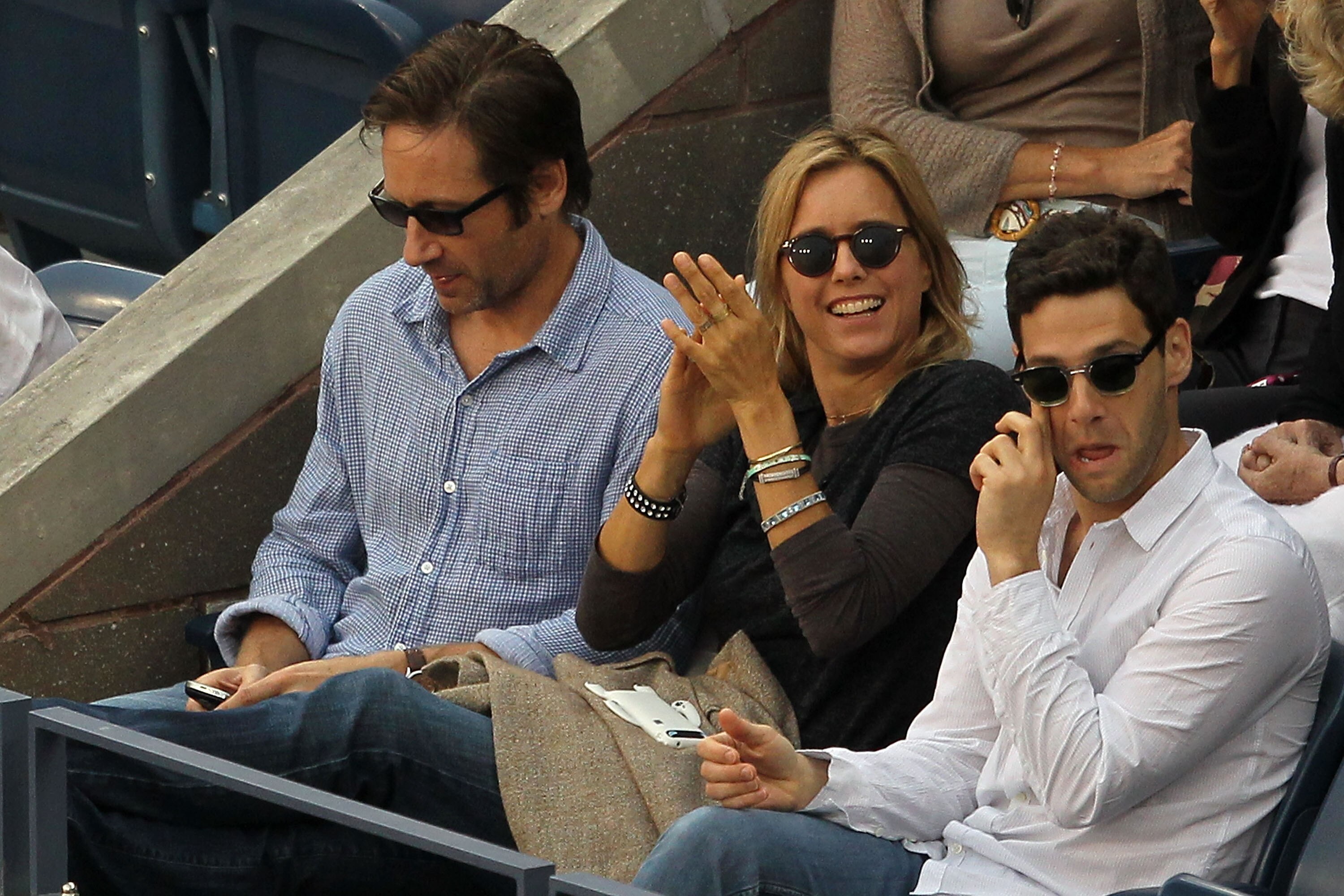 NEW YORK - SEPTEMBER 13:  David Duchovny, Tea Leoni and Justin Bartha look on during the men's singles final match between Novak Djokovic of Serbia and Rafael Nadal of Spain during day fifteen of the 2010 U.S. Open at the USTA Billie Jean King National Te