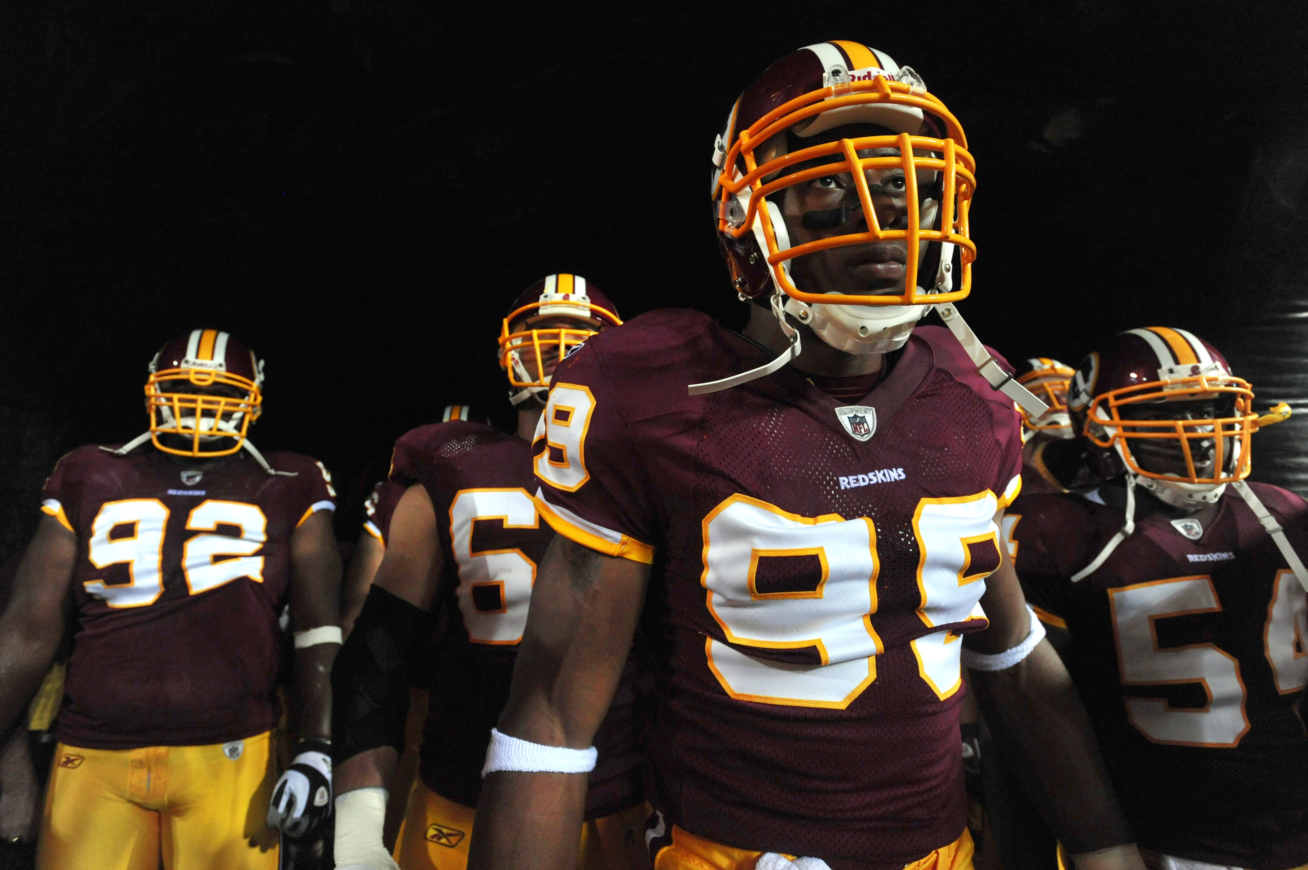 LANDOVER - SEPTEMBER 12:  Andre Carter #99 of the Washington Redskins prepares to run onto the field before the NFL season opener against the Dallas Cowboys at FedExField on September 12, 2010 in Landover, Maryland.  (Photo by Larry French/Getty Images)