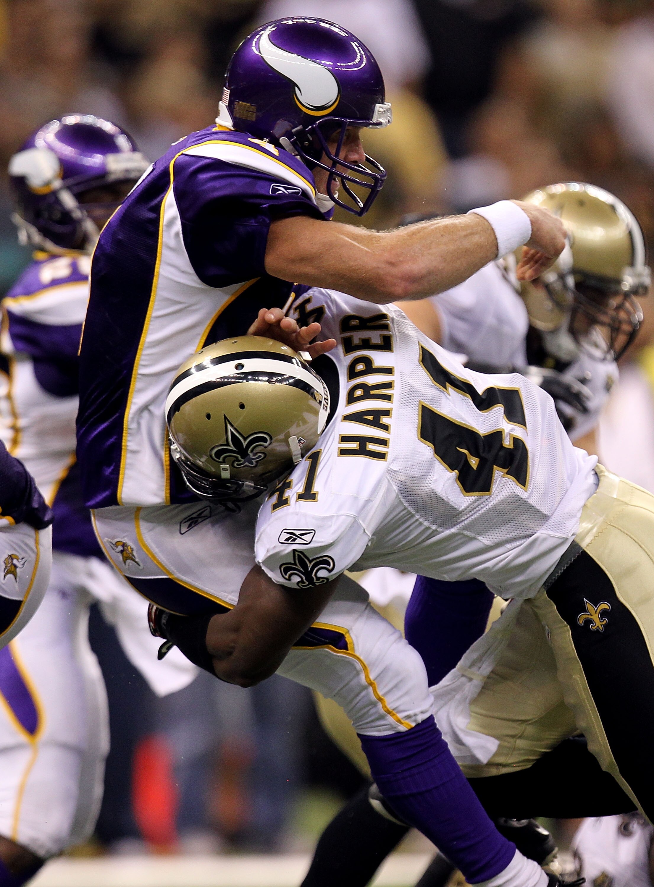NEW ORLEANS - SEPTEMBER 09:  Quarterback Brett Favre #4 of the Minnesota Vikings takes a hard hit from Roman Harper #41 of the New Orleans Saints at Louisiana Superdome on September 9, 2010 in New Orleans, Louisiana.  (Photo by Ronald Martinez/Getty Image