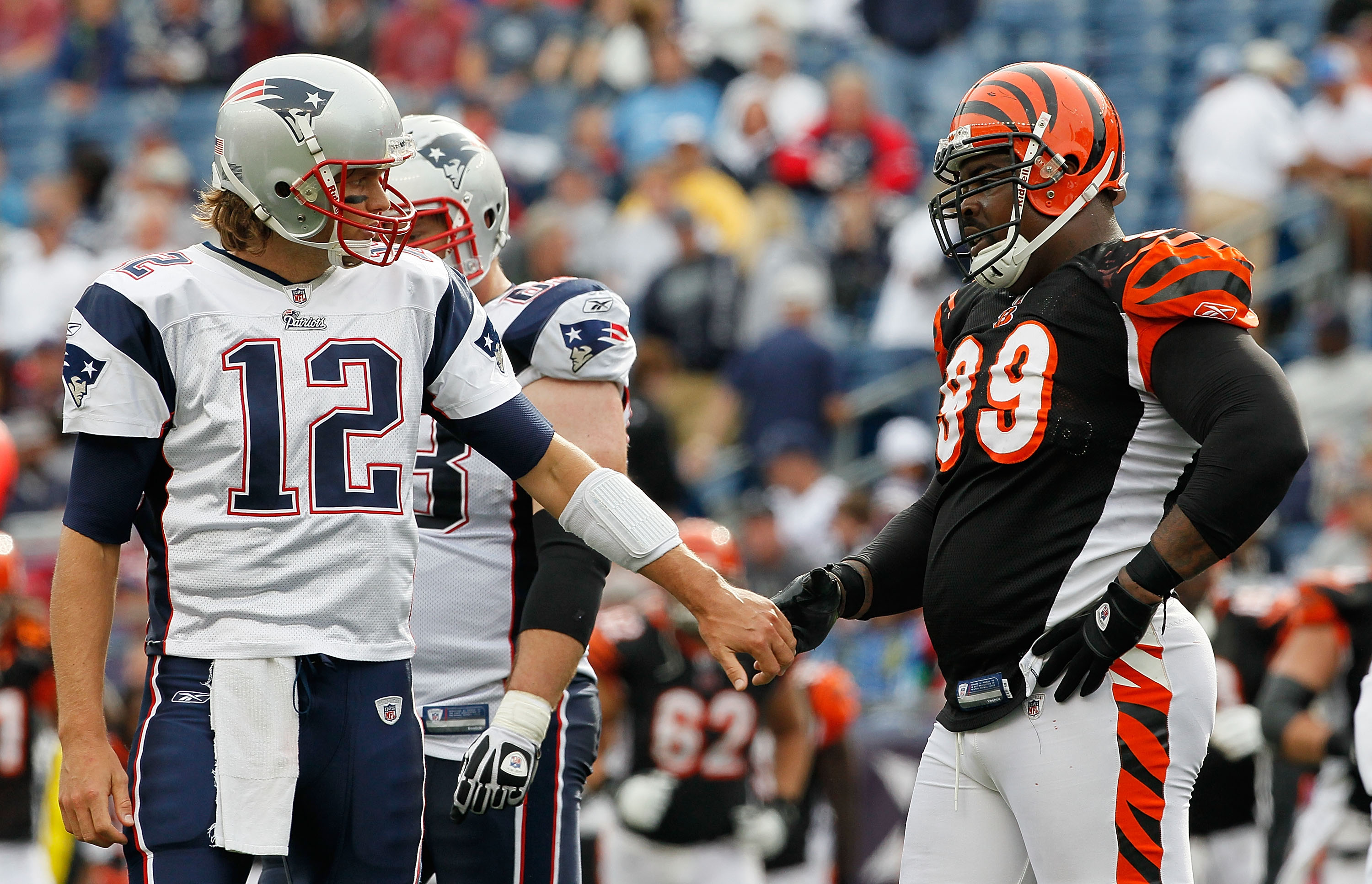 FOXBORO, MA - SEPTEMBER 12: Quarterbacks Tom Brady #12 of the New England Patriots shakes hands with Tank Johnson #99 of the Cincinnati Bengals during a the NFL season opener against the Cincinnati Bengals at Gillette Stadium on September 12, 2010 in Foxb