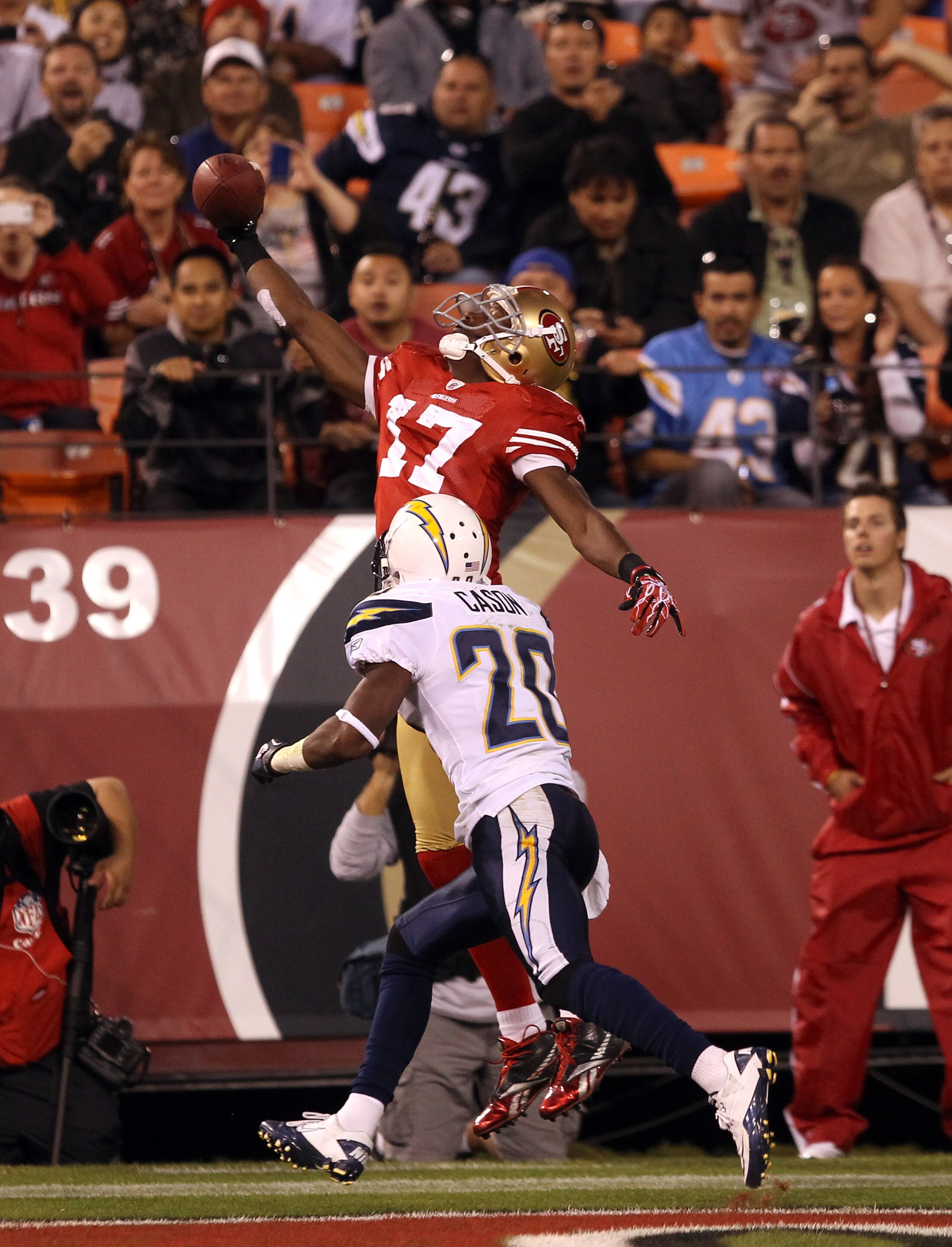 SAN FRANCISCO - SEPTEMBER 02: Dominique Zeigler #17 of the San Francisco 49ers leaps over Antoine Cason #20 of the San Diego Chargers at Candlestick Park  on September 2, 2010 in San Francisco, California. The catch was ruled incomplete upon review by ins
