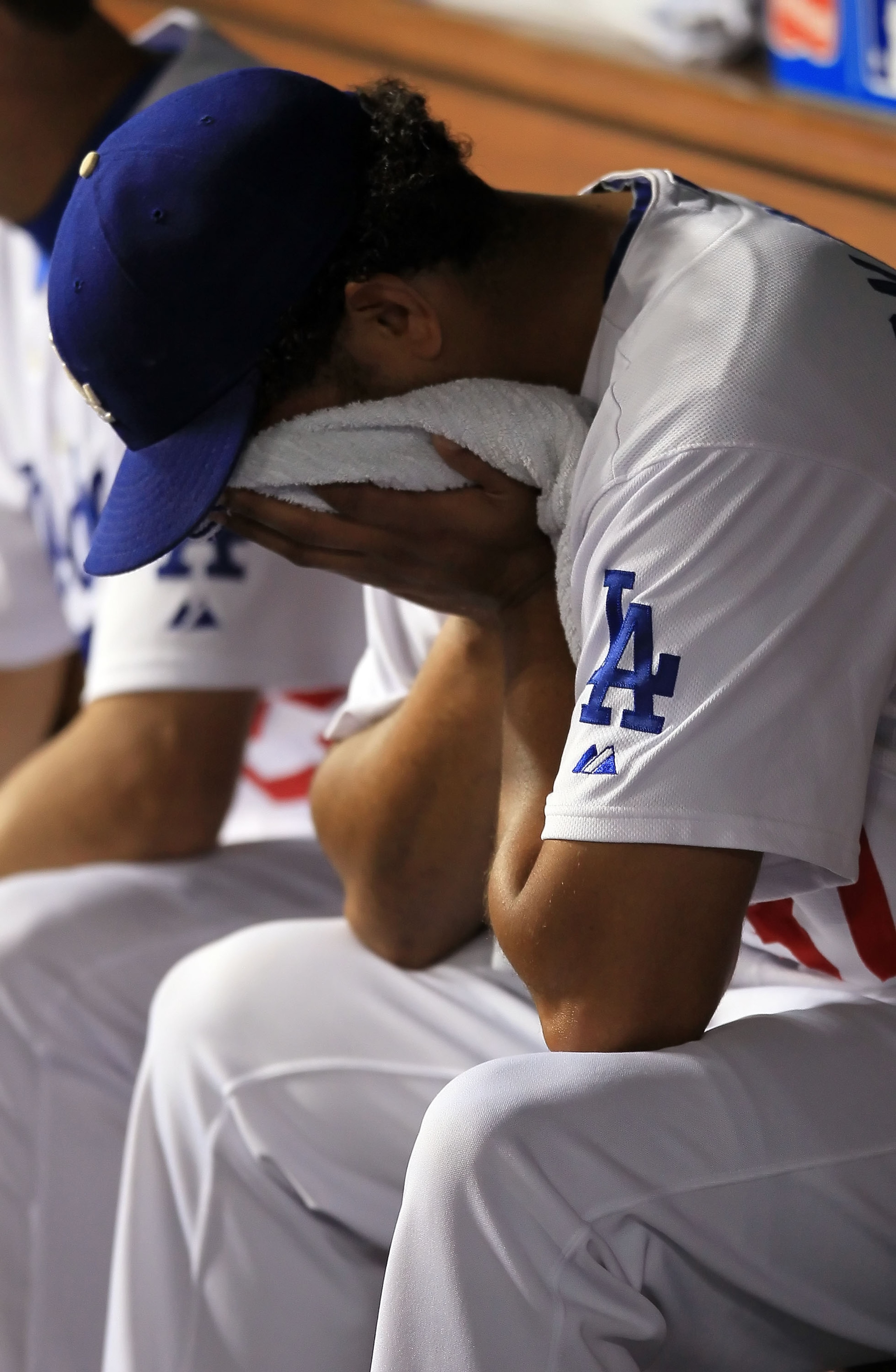 LOS ANGELES, CA - AUGUST 31: Pitcher Carlos Monasterios #37 of the Los Angeles Dodgers buries his head in the dugout after giving up a three-run home run to Brian Schneider of the Philadelphia Phillies in the second inning at Dodger Stadium on August 31, LOS ANGELES, CA - AUGUST 31: Pitcher Carlos Monasterios #37 of the Los Angeles Dodgers buries his head in the dugout after giving up a three-run home run to Brian Schneider of the Philadelphia Phillies in the second inning at Dodger Stadium on August 31,