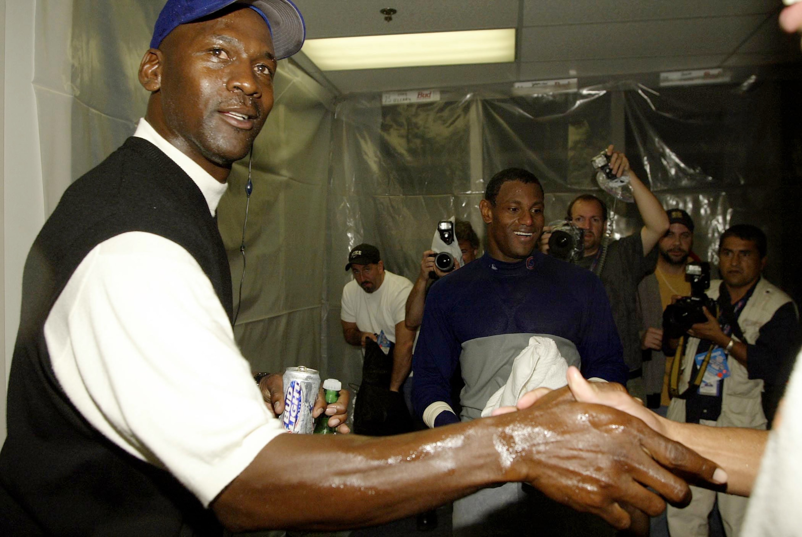 ATLANTA - OCTOBER 5:  Former Chicago Bull Michael Jordan celebrates with Sammy Sosa #21 and the Chicago Cubs in the locker room after the Chicago Cubs defeated the Atlanta Braves 5-1 during Game 5 of the National League Division Series between the Chicago