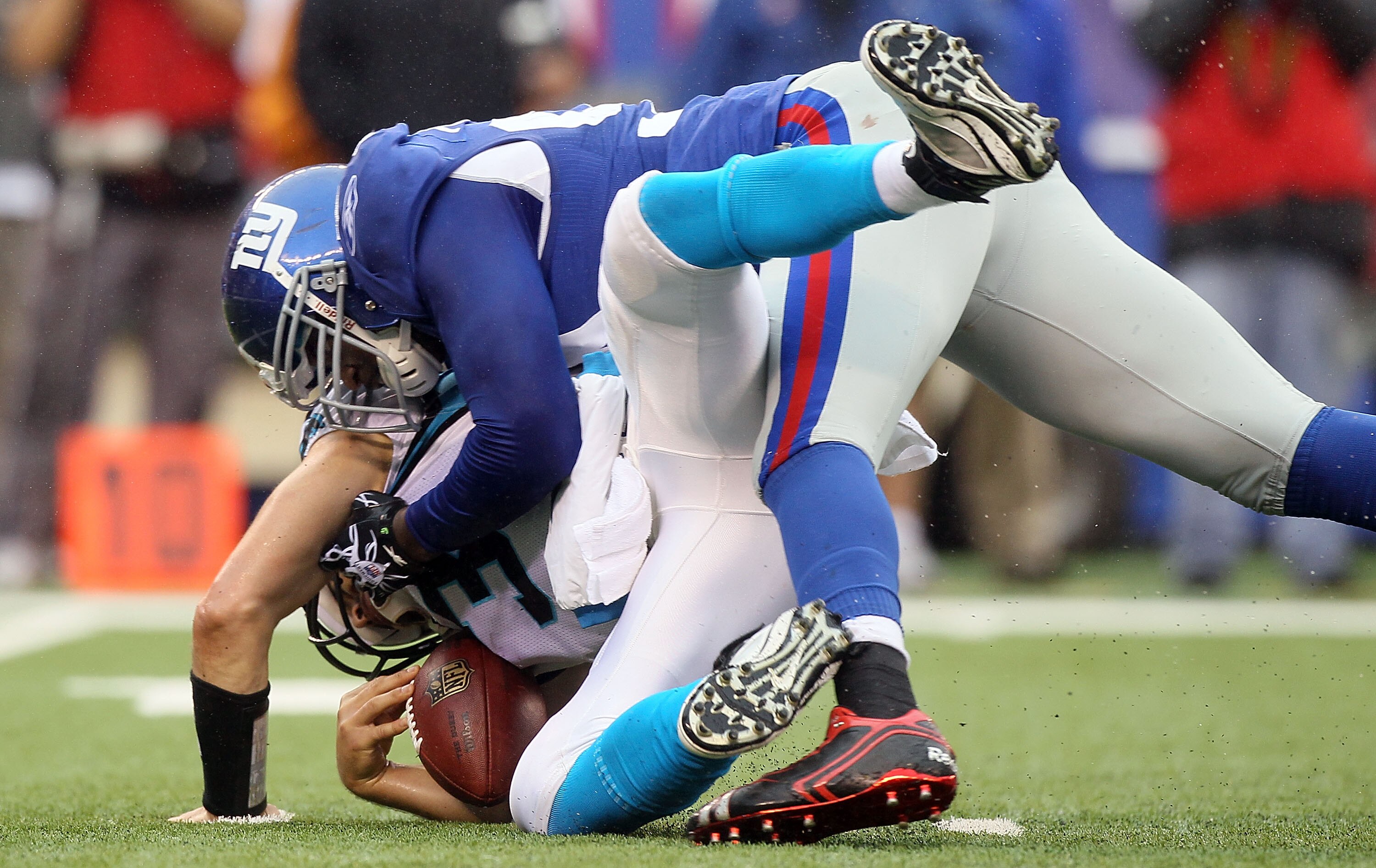 EAST RUTHERFORD, NJ - SEPTEMBER 12:  Matt Moore #3 of the Carolina Panthers is sacked in the fourth quarter by Mathias Kiwanuka #94 of the New York Giants on September 12, 2010 at the New Meadowlands Stadium in East Rutherford, New Jersey. The Giants defe
