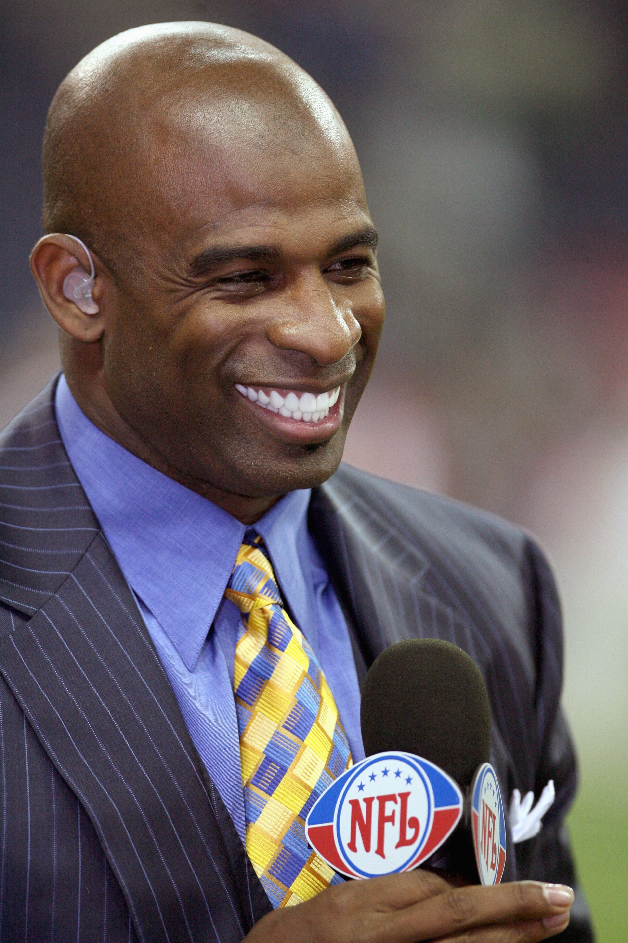 HOUSTON - DECEMBER 13:  NFL network broadcaster Dion Sanders talks during the NFL game of the Houston Texans against the Denver Broncos at  Reliant Stadium on December 13, 2007 in Houston, Texas. (Photo by Thomas B.  Shea/Getty Images)