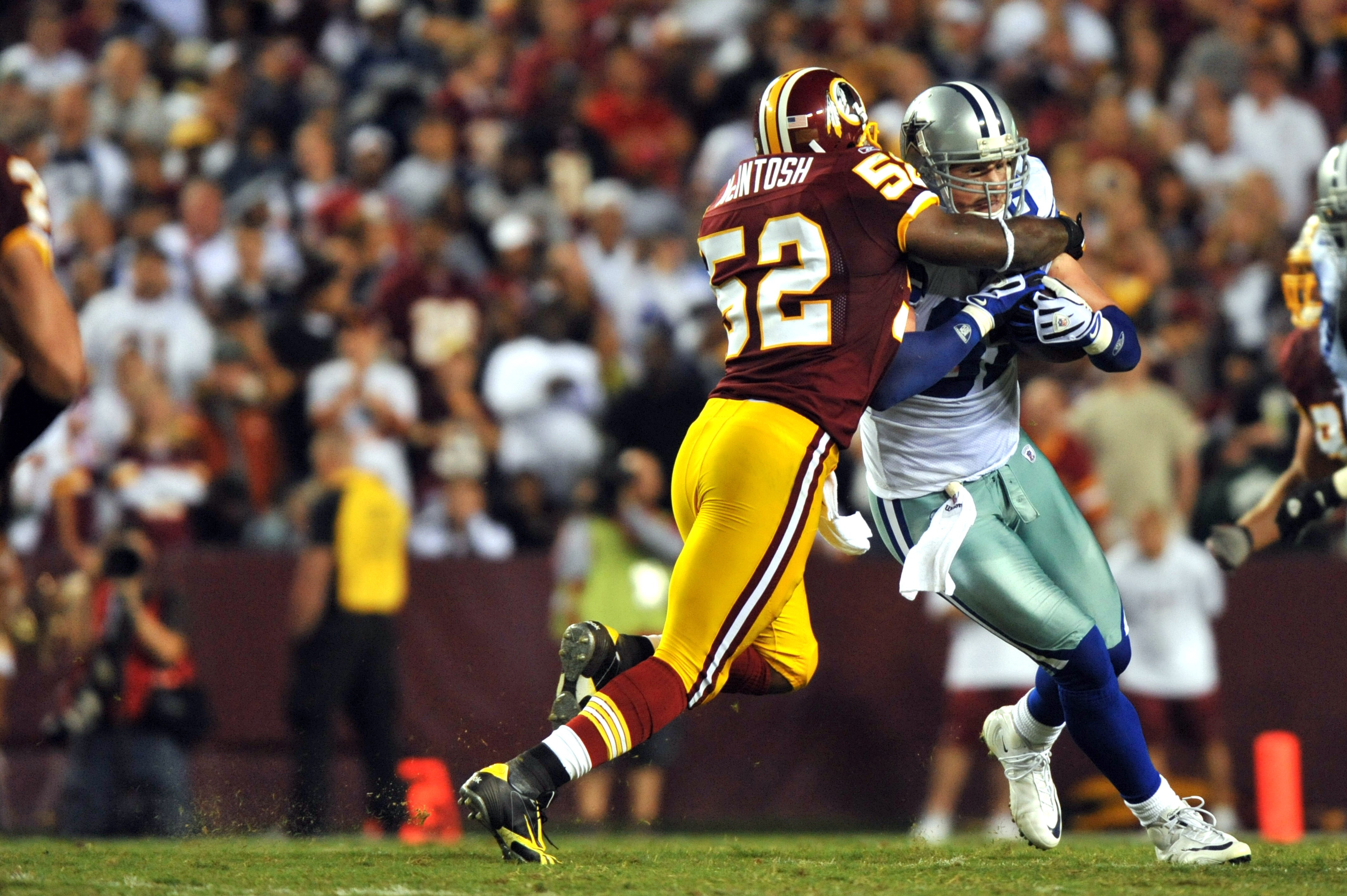 LANDOVER - SEPTEMBER 12:  Rocky McIntosh #52 of the Washington Redskins tackles Jason Witten #82 of the Dallas Cowboys during the NFL season opener against the Dallas Cowboys at FedExField on September 12, 2010 in Landover, Maryland. The Redskins defeated