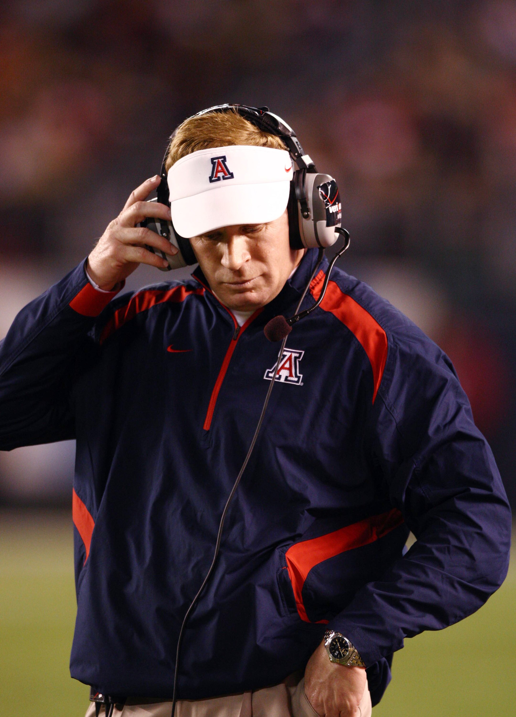 SAN DIEGO, CA - DECEMBER 30:  Head Coach Mike Stoops of Arizona Wildcatslooks down from the sidelines against the University of Nebraska Cornhuskers during the Pacific Life Holiday Bowl, on December 30, 2009 at Qualcomm Stadium in San Diego, California. (