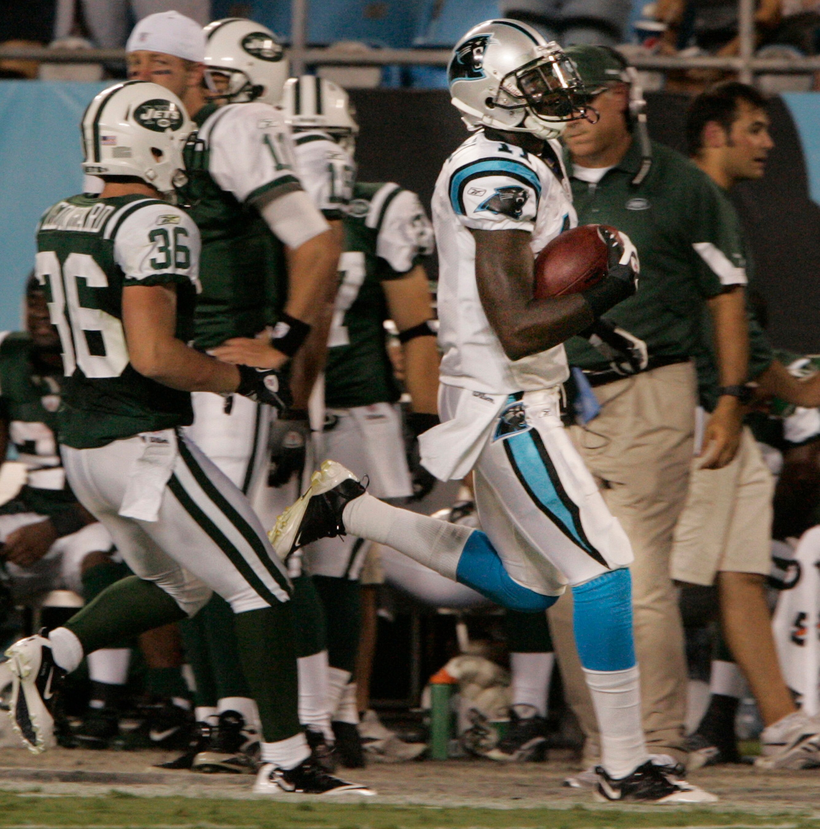 CHARLOTTE, NC - AUGUST 21:  Wade Receiver Brandon LaFell #11 of the Carolina Panthers runs out of bounds as Jim Leonhard #36 of the New York Jets peruses during their preseason game at Bank of America Stadium on August 21, 2010 in Charlotte, North Carolin