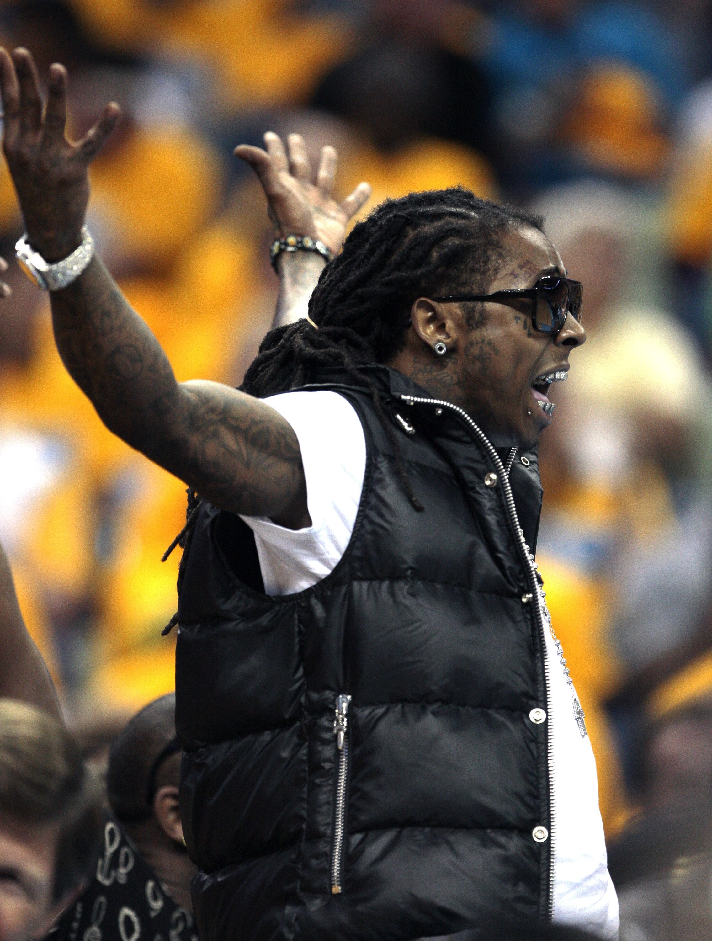 NEW ORLEANS - APRIL 25:  Rapper Lil Wayne has words with Carmelo Anthony of the Denver Nuggets during Game Three of the Western Conference Quarterfinals against the New Orleans Hornets during the 2009 NBA Playoffs at New Orleans Arena on April 25, 2009 in