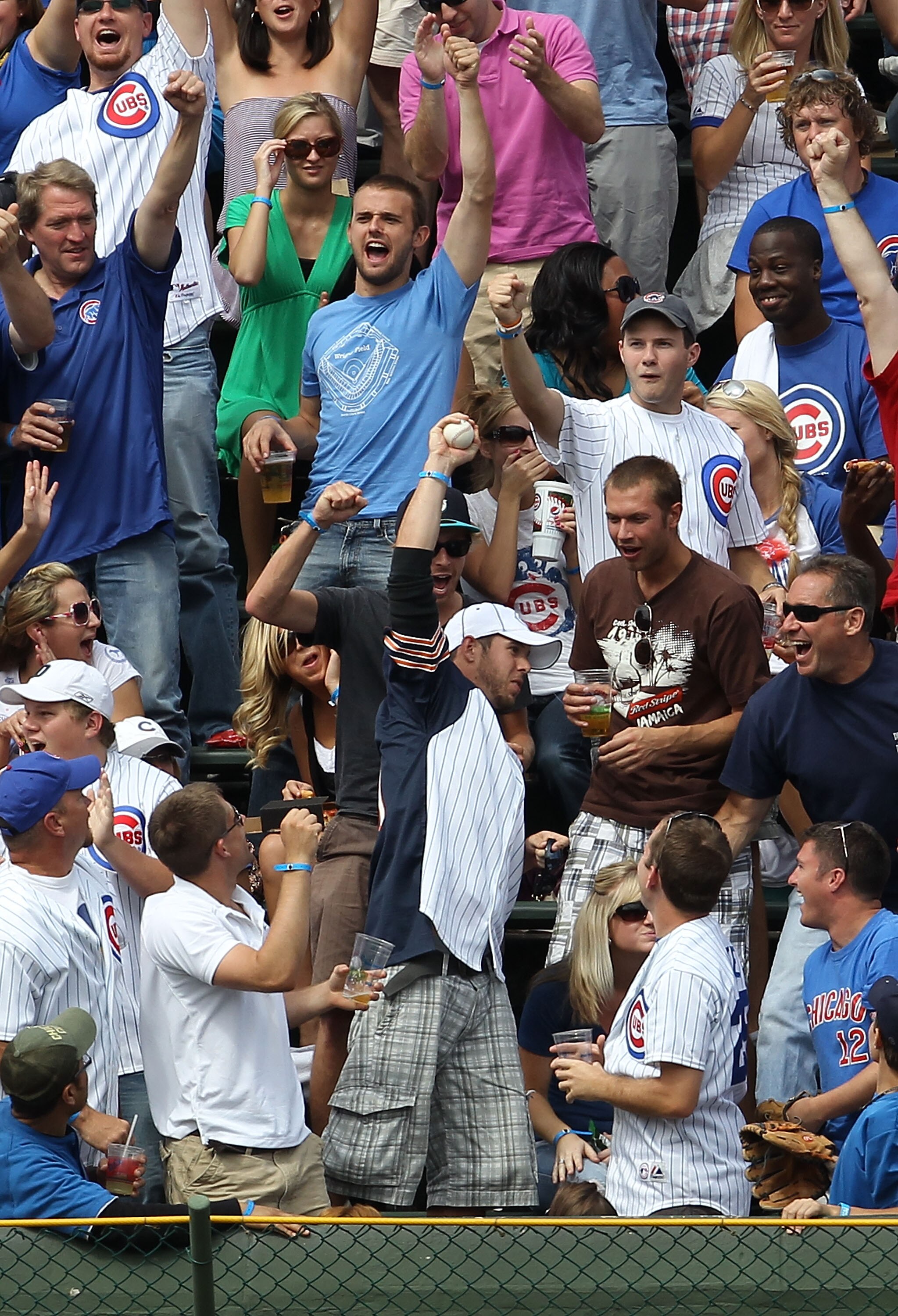 CHICAGO - SEPTEMBER 05: A fan in the left field bleachers holds up a home run ball hit by Aramis Ramirez of the Chicago Cubs against the New York Mets at Wrigley Field on September 5, 2010 in Chicago, Illinois. (Photo by Jonathan Daniel/Getty Images)