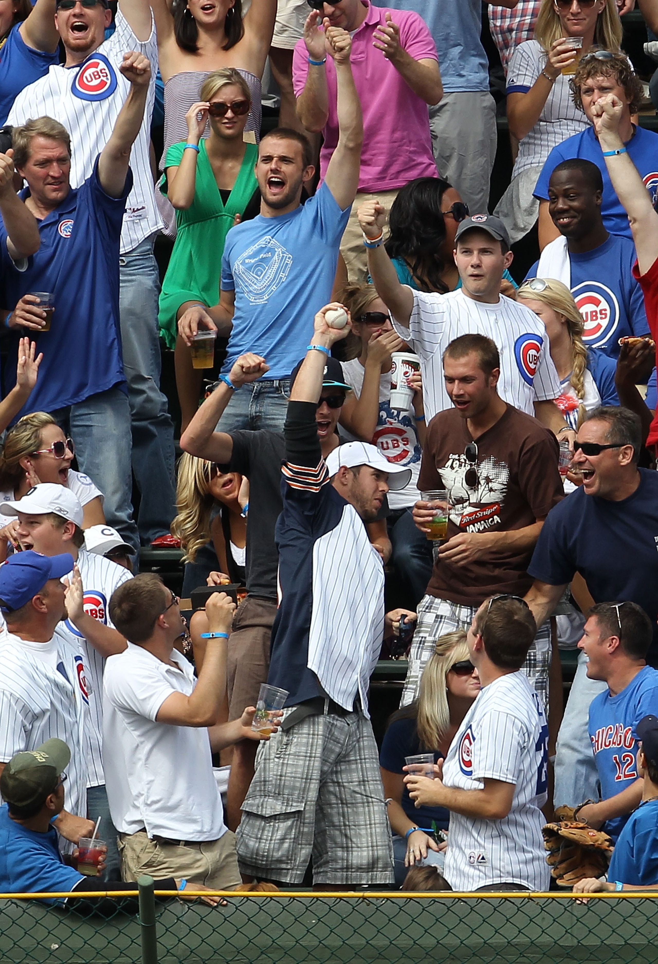 CHICAGO - SEPTEMBER 05: A fan in the left field bleachers holds up a home run ball hit by Aramis Ramirez of the Chicago Cubs against the New York Mets at Wrigley Field on September 5, 2010 in Chicago, Illinois. (Photo by Jonathan Daniel/Getty Images) CHICAGO - SEPTEMBER 05: A fan in the left field bleachers holds up a home run ball hit by Aramis Ramirez of the Chicago Cubs against the New York Mets at Wrigley Field on September 5, 2010 in Chicago, Illinois. (Photo by Jonathan Daniel/Getty Images)