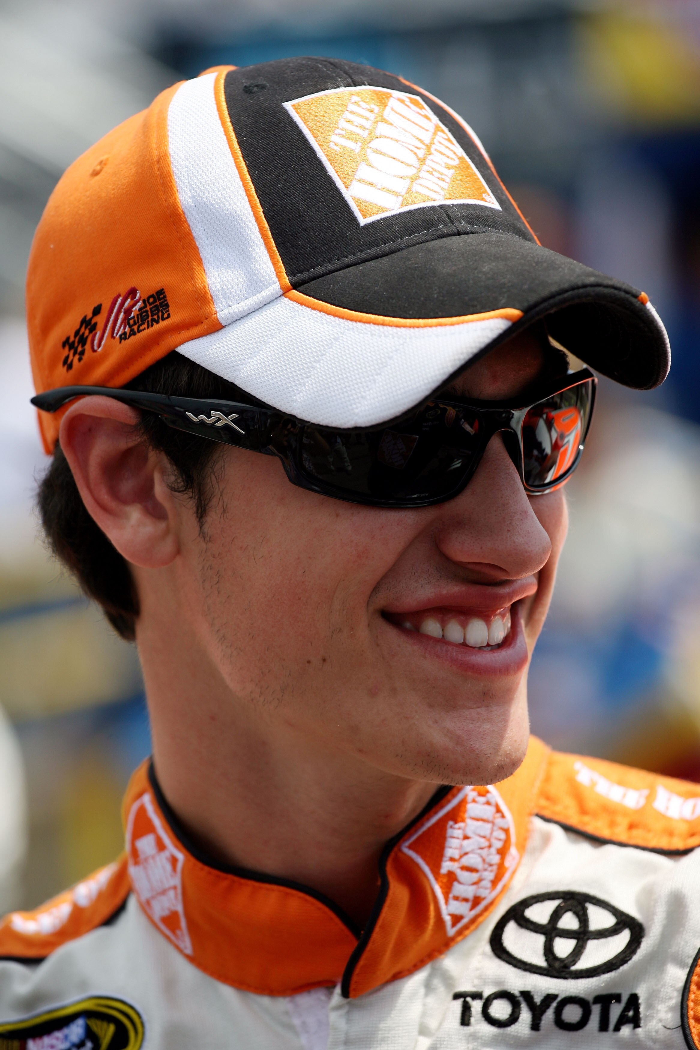 WATKINS GLEN, NY - AUGUST 08:  Joey Logano, driver of the #20 Home Depot Toyota, stands on the grid prior to the NASCAR Sprint Cup Series Heluva Good! Sour Cream Dips at Watkins Glen International on August 8, 2010 in Watkins Glen, New York.  (Photo by Ch