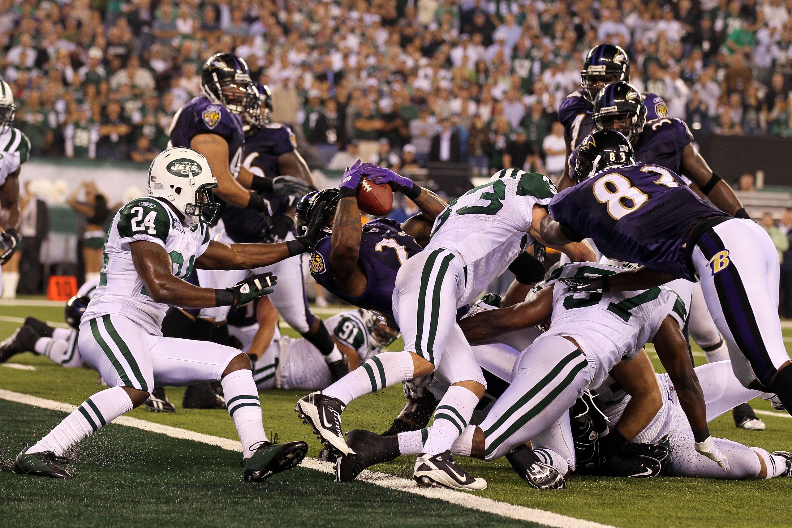 EAST RUTHERFORD, NJ - SEPTEMBER 13:  Willis McGahee #23 of the Baltimore Ravens scores a touchdown against Darrelle Revis #24 of the New York Jets during their home opener at the New Meadowlands Stadium on September 13, 2010 in East Rutherford, New Jersey