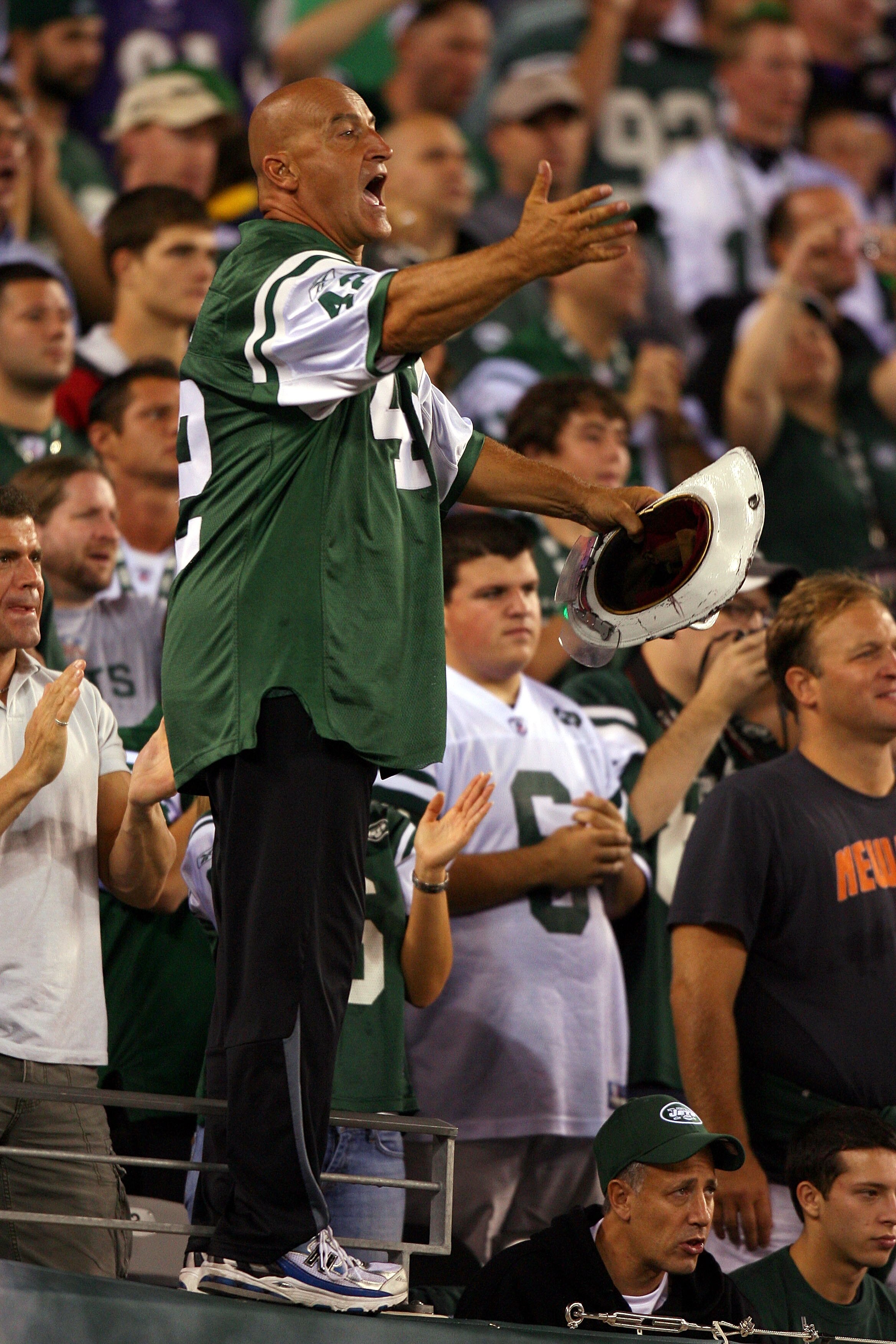 EAST RUTHERFORD, NJ - SEPTEMBER 13:  New York Jets fan fireman Ed Anzalone cheers for the New York Jets during their home opener against the Baltimore Ravens at the New Meadowlands Stadium on September 13, 2010 in East Rutherford, New Jersey.  (Photo by A