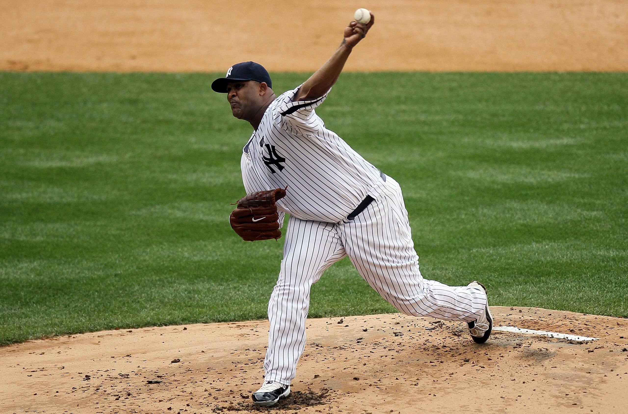 NEW YORK - AUGUST 22:  CC Sabathia #52 of the New York Yankees delivers a pitch against the Seattle Mariners on August 22, 2010 at Yankee Stadium in the Bronx borough of New York City.  (Photo by Jim McIsaac/Getty Images)