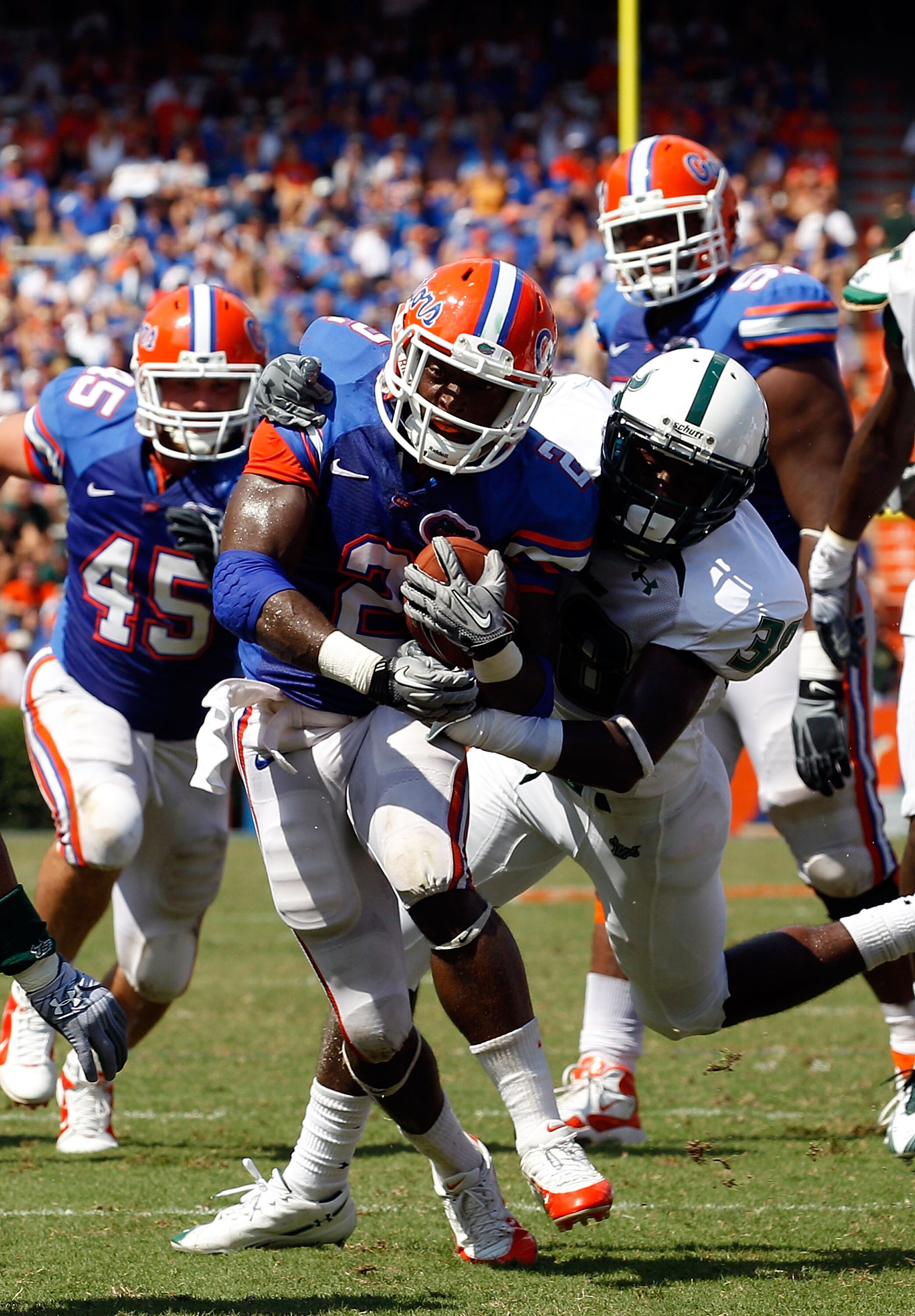 GAINESVILLE, FL - SEPTEMBER 11:  Jeffery Demps #2 of the Florida Gators breaks the tackle of Ricardo Dixon #38 of the South Florida Bulls during a game at Ben Hill Griffin Stadium on September 11, 2010 in Gainesville, Florida.  (Photo by Sam Greenwood/Get