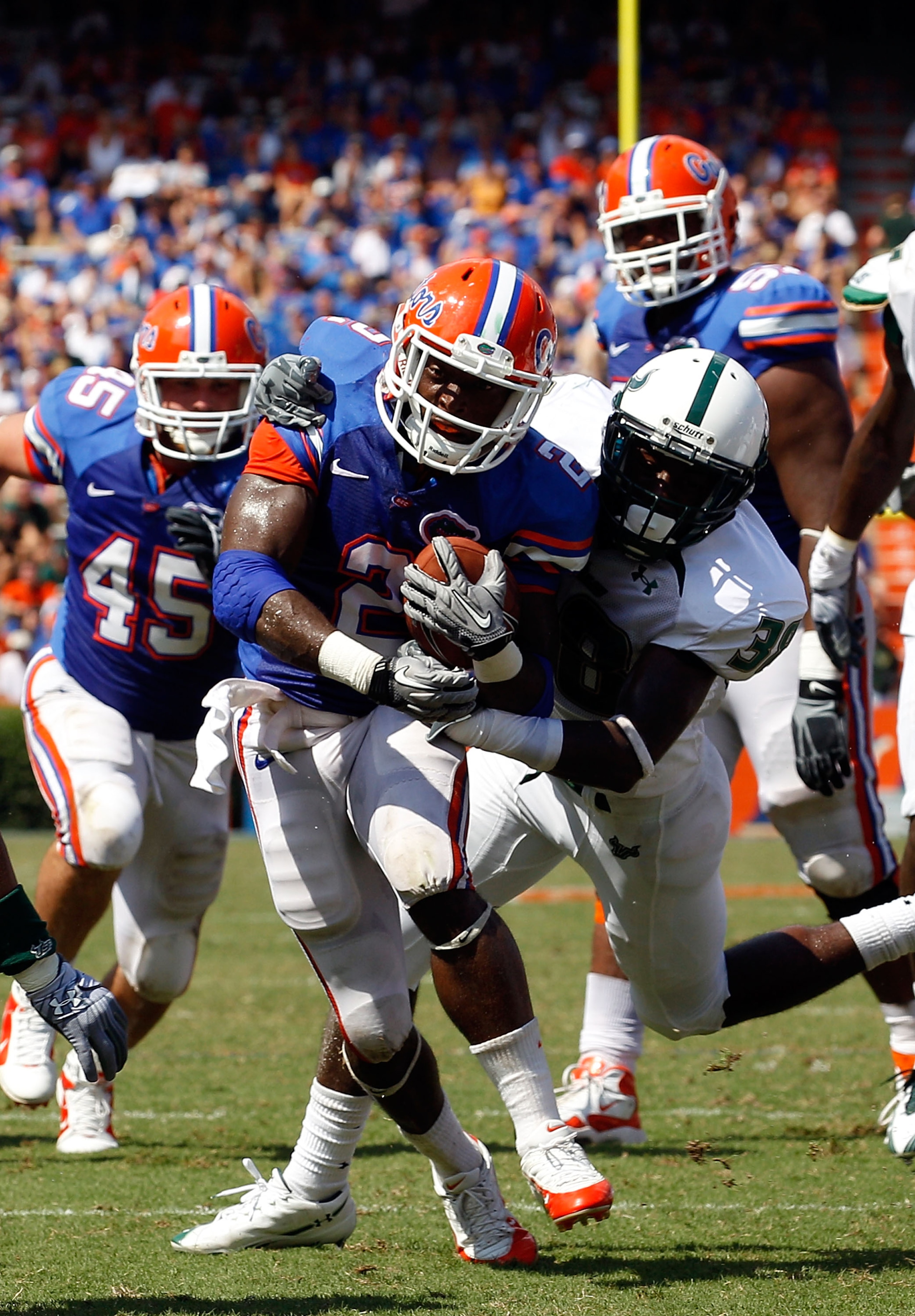 GAINESVILLE, FL - SEPTEMBER 11:  Jeffery Demps #2 of the Florida Gators breaks the tackle of Ricardo Dixon #38 of the South Florida Bulls during a game at Ben Hill Griffin Stadium on September 11, 2010 in Gainesville, Florida.  (Photo by Sam Greenwood/Get