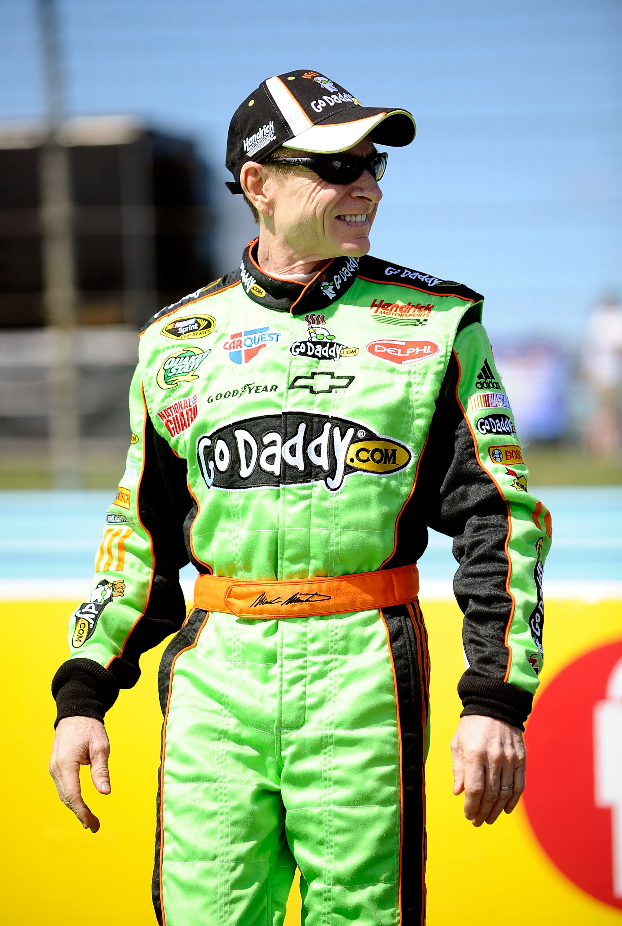 WATKINS GLEN, NY - AUGUST 07:  Mark Martin, driver of the #5 GoDaddy.com Chevrolet, stands on the grid during qualifying for the NASCAR Sprint Cup Series Heluva Good! Sour Cream Dips at Watkins Glen International on August 7, 2010 in Watkins Glen, New Yor