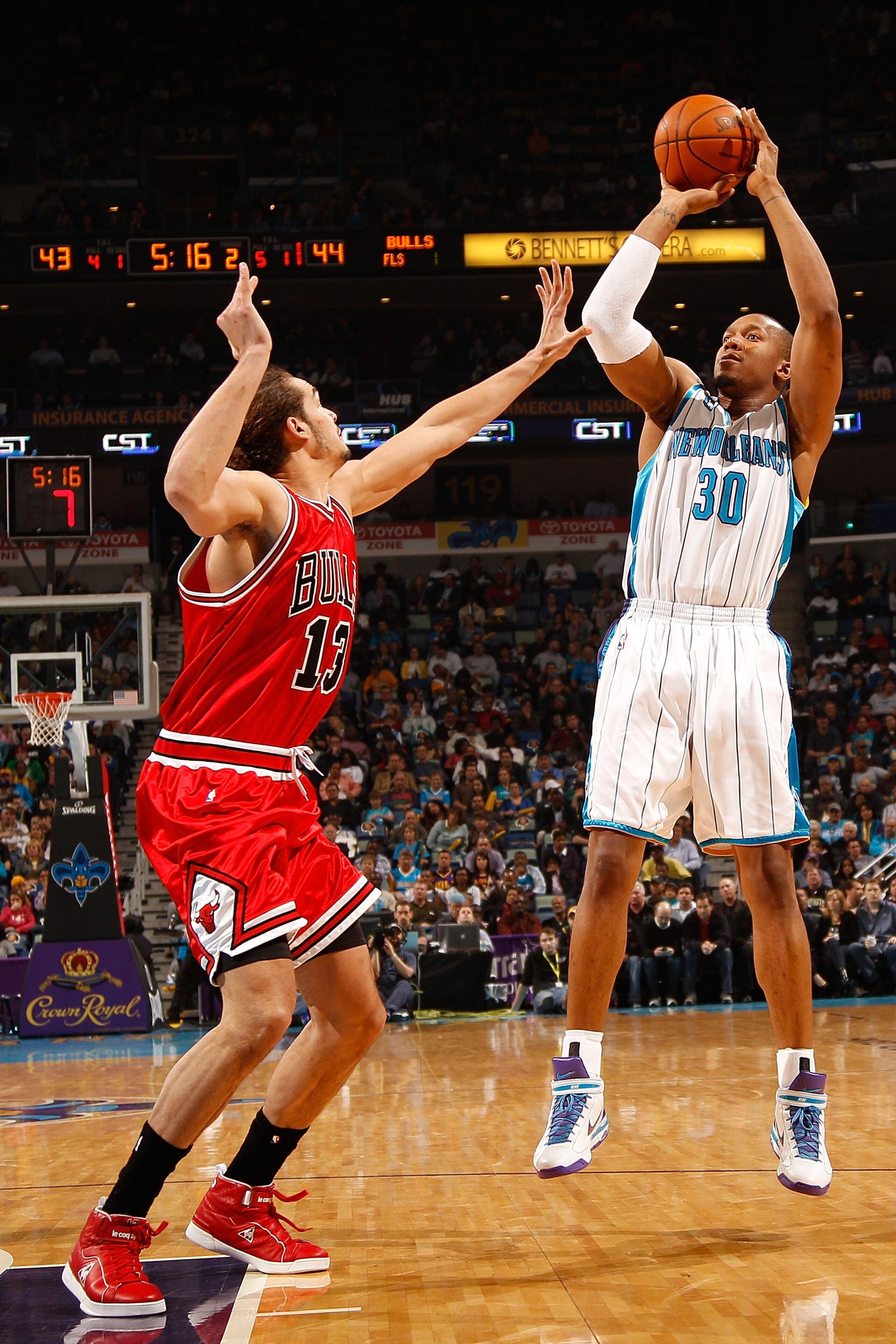 NEW ORLEANS - JANUARY 29: David West #3 of the New Orleans Hornets shoots the ball over Joakim Noah #13 of the Chicago Bulls at the New Orleans Arena on January 29, 2010 in New Orleans, Louisiana. NOTE TO USER: User expressly acknowledges and agrees th NEW ORLEANS - JANUARY 29: David West #3 of the New Orleans Hornets shoots the ball over Joakim Noah #13 of the Chicago Bulls at the New Orleans Arena on January 29, 2010 in New Orleans, Louisiana. NOTE TO USER: User expressly acknowledges and agrees th