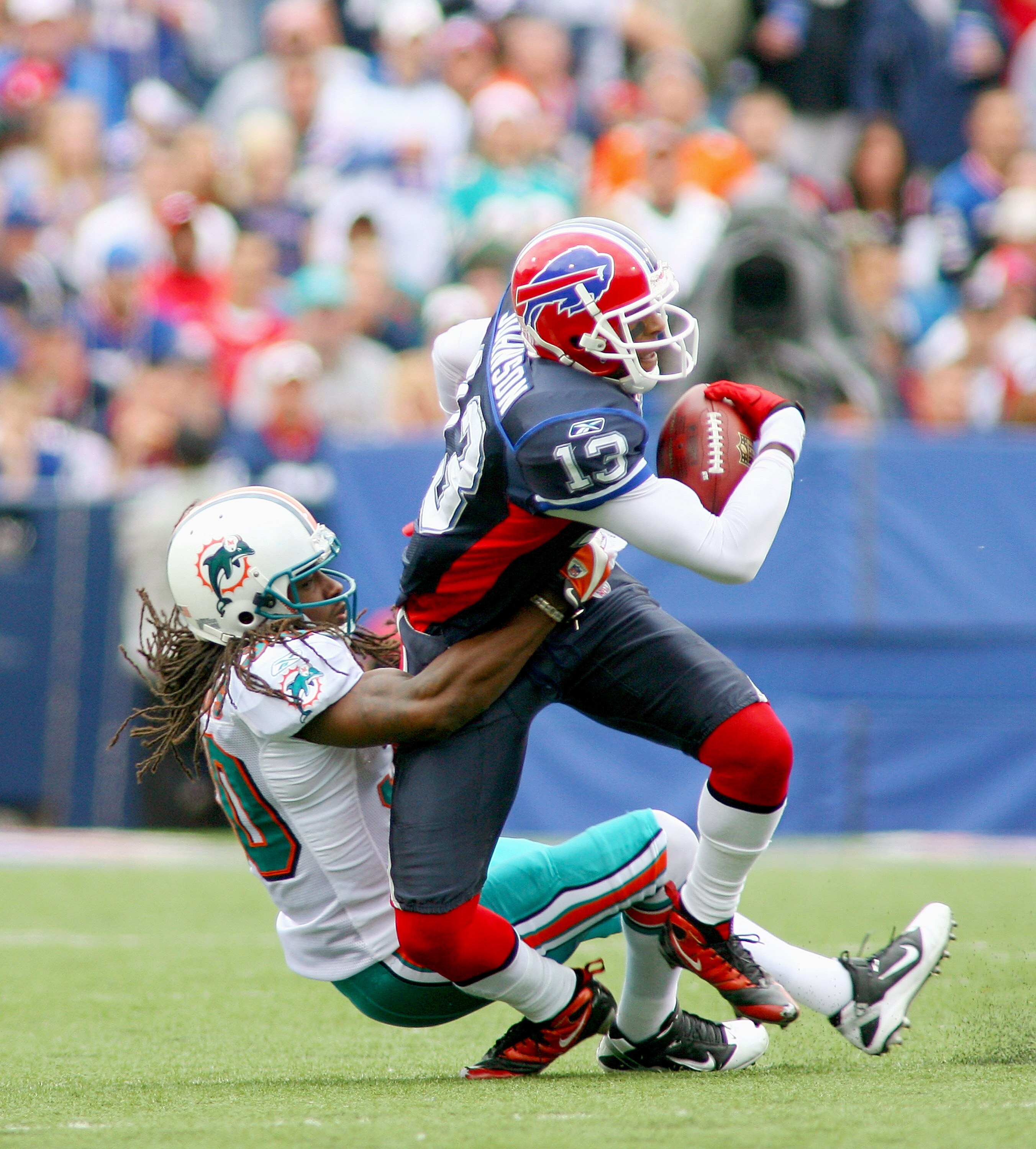 ORCHARD PARK, NY - SEPTEMBER 12: Chris Clemons #30 of the Miami Dolphins tackles Steve Johnson #13 of the Buffalo Bills  during the NFL season opener at Ralph Wilson Stadium on September 12, 2010 in Orchard Park, New York. Miami won 15-10. (Photo by Rick