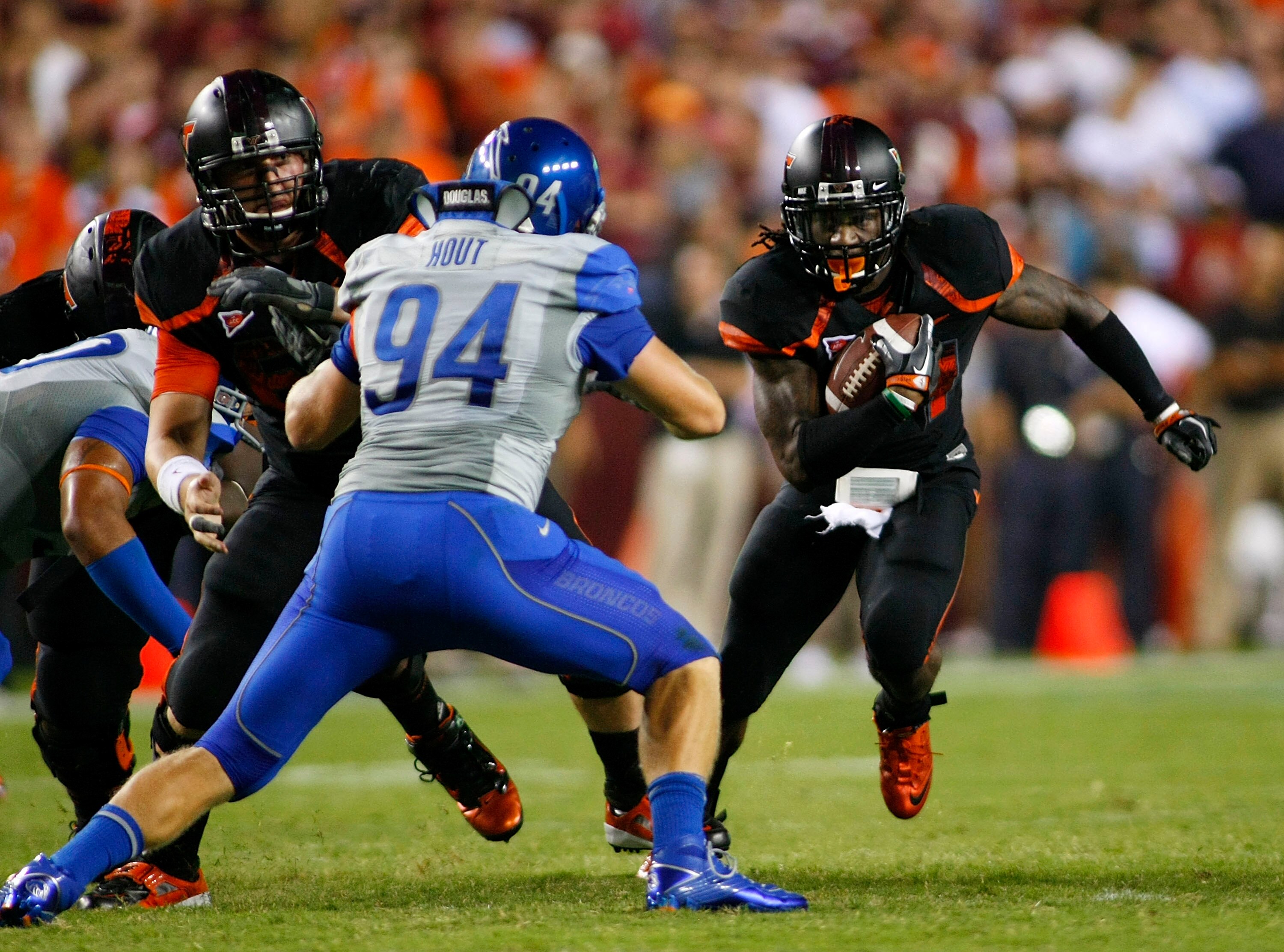 LANDOVER, MD - SEPTEMBER 06:  Running back Ryan Williams #34 of the Virginia Tech Hokies runs with the ball as linebacker Byron Hout #94 of the Boise State Broncos defends at FedExField on September 6, 2010 in Landover, Maryland.  (Photo by Geoff Burke/Ge