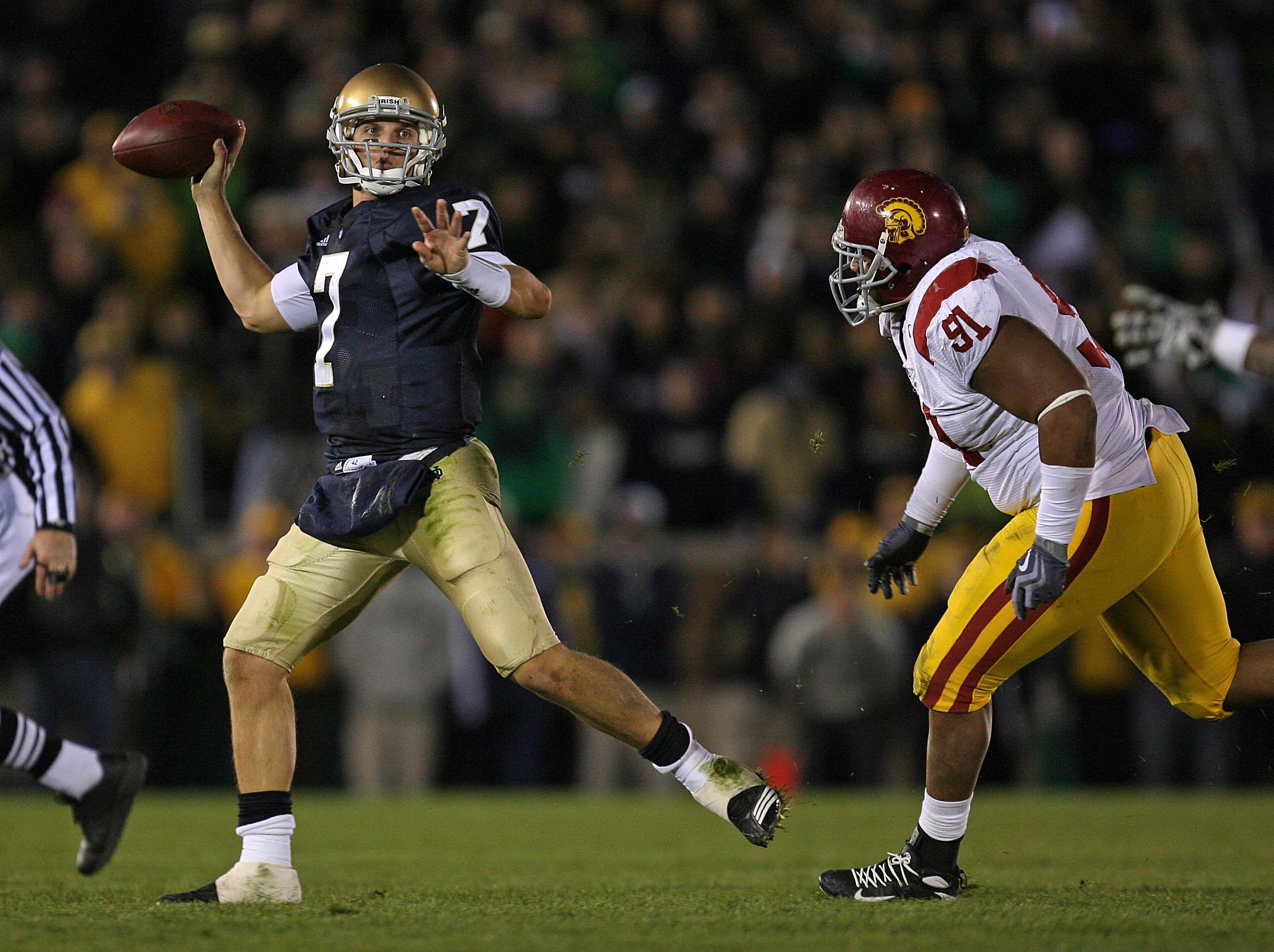 SOUTH BEND, IN - OCTOBER 17: Jimmy Clausen #7 of the Notre Dame Fighting Irish throws a pass as Jurrell Casey #91 of the USC Trojans purses at Notre Dame Stadium on October 17, 2009 in South Bend, Indiana. USC defeated Notre Dame 34-27. (Photo by Jonathan
